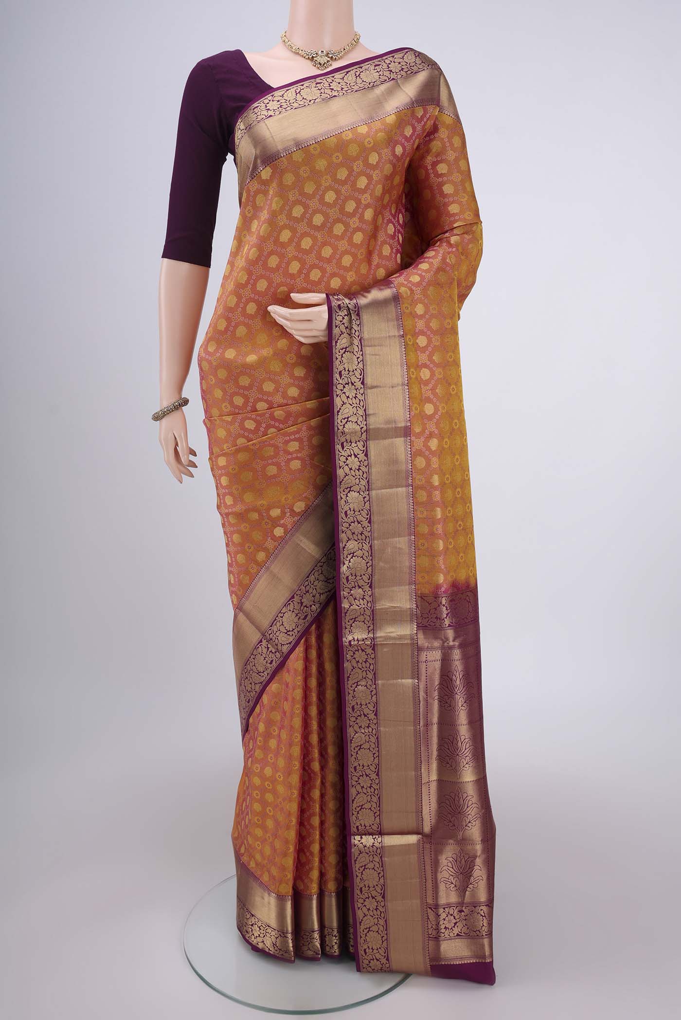 Pinkish Yellow Soft Silk Saree with Zari Brocade on the body and Zari Border.  displayed on a mannequin