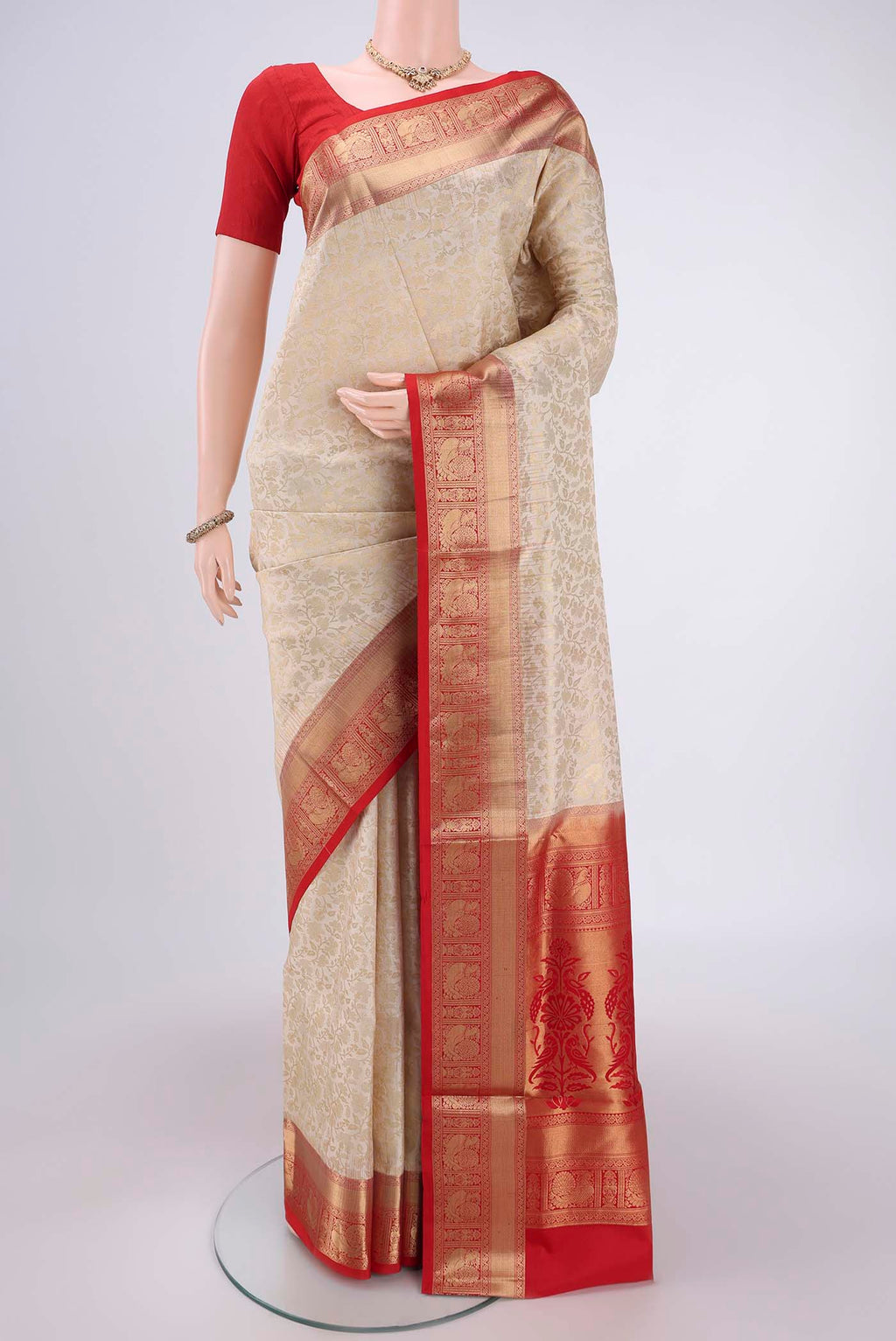 Off White Soft Silk Saree with Zari Brocade on the body and Zari Border.  displayed on a mannequin