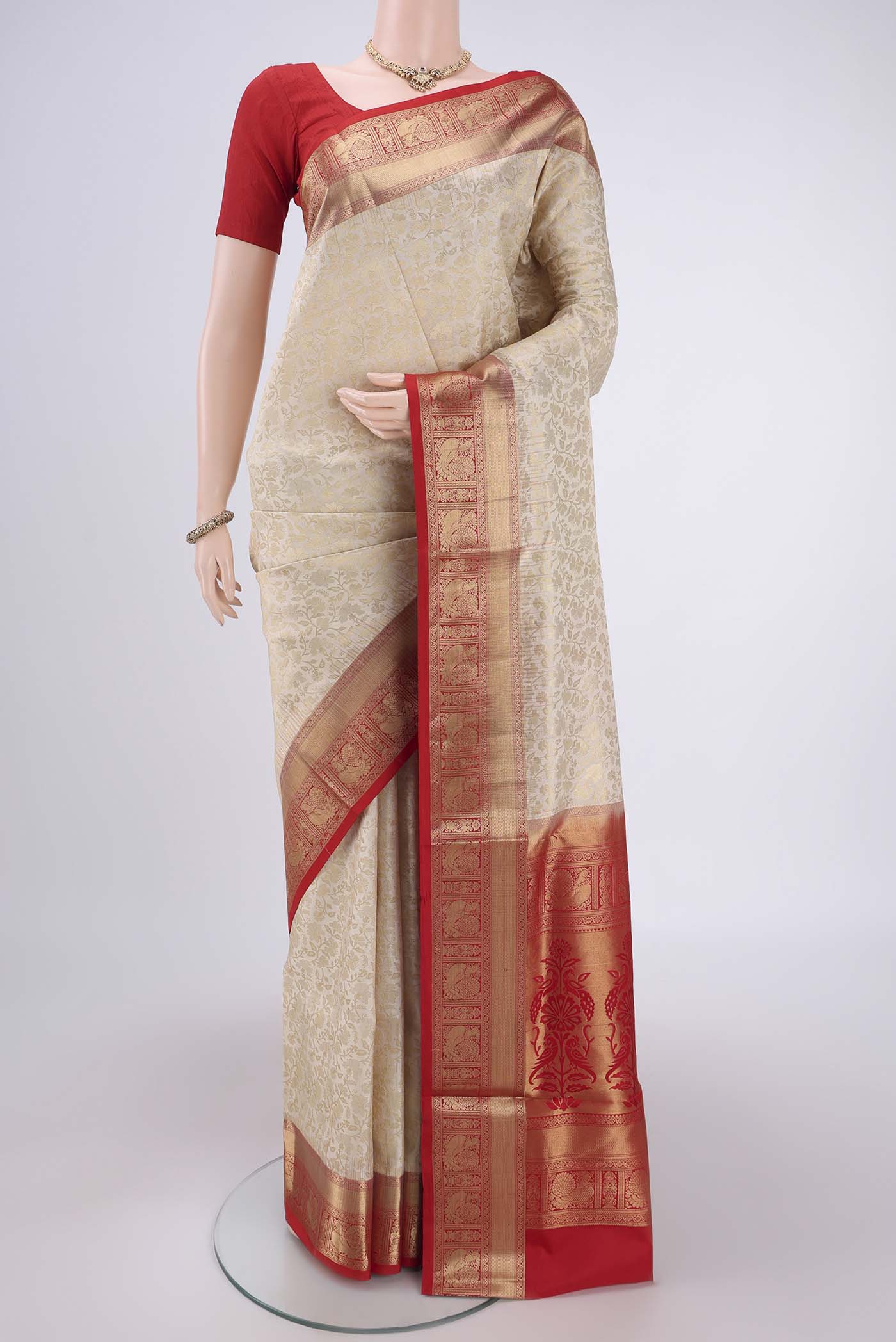 Off White Soft Silk Saree with Zari Brocade on the body and Zari Border.  displayed on a mannequin