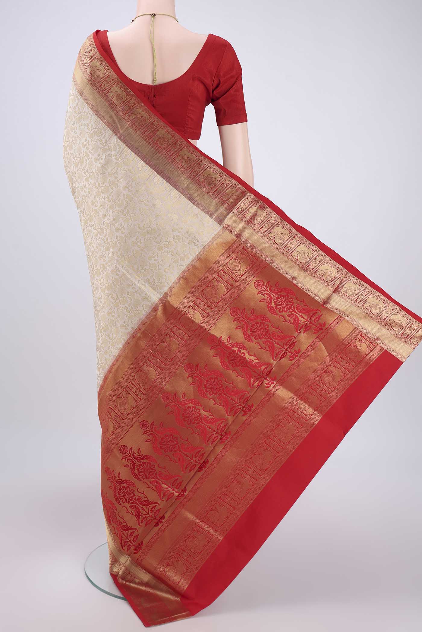 Flat view of Off White Soft Silk Saree with Zari Brocade on the body and Zari Border. 