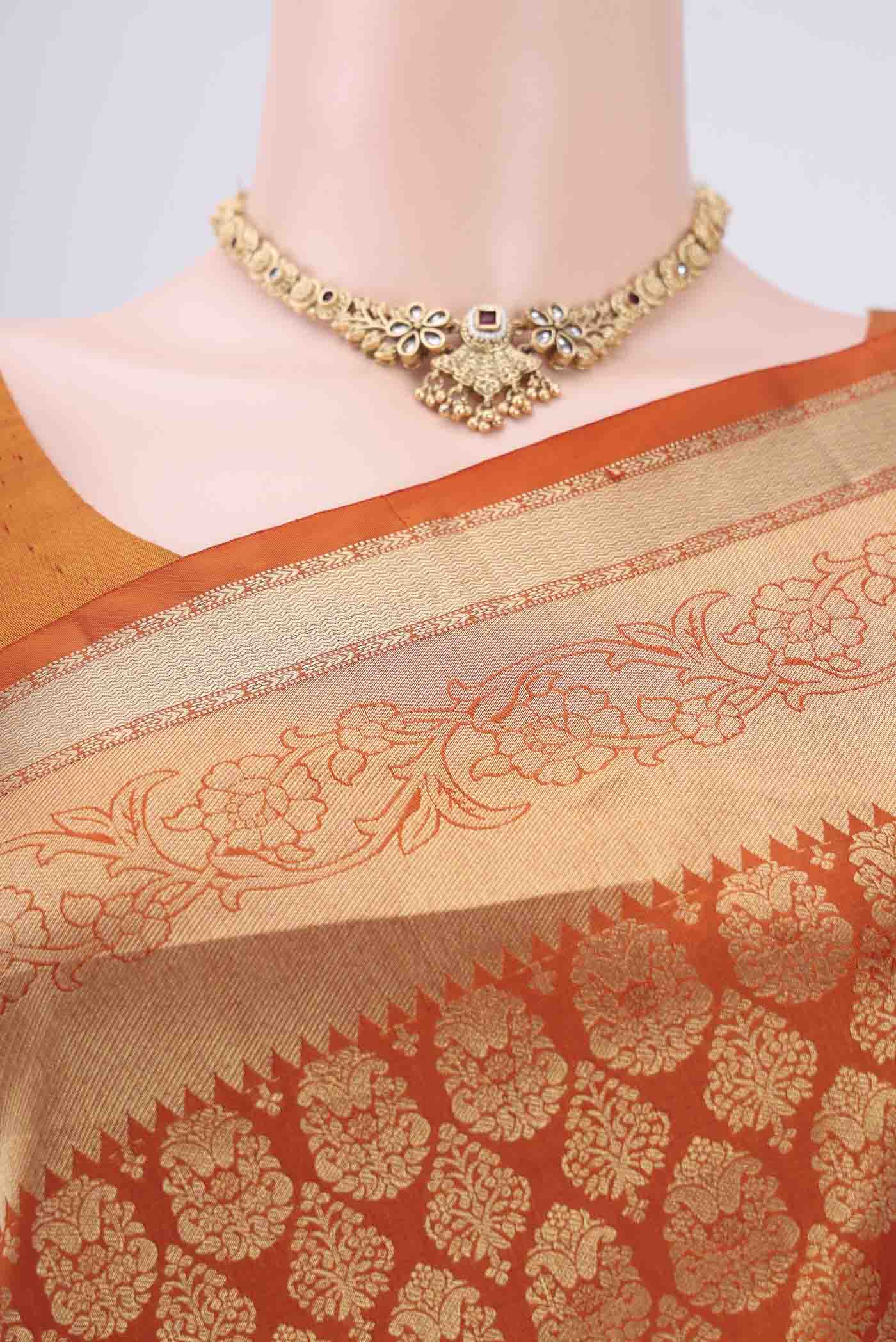 Border image of Rust Soft Silk Saree with Zari Brocade on the body and Zari Border. 