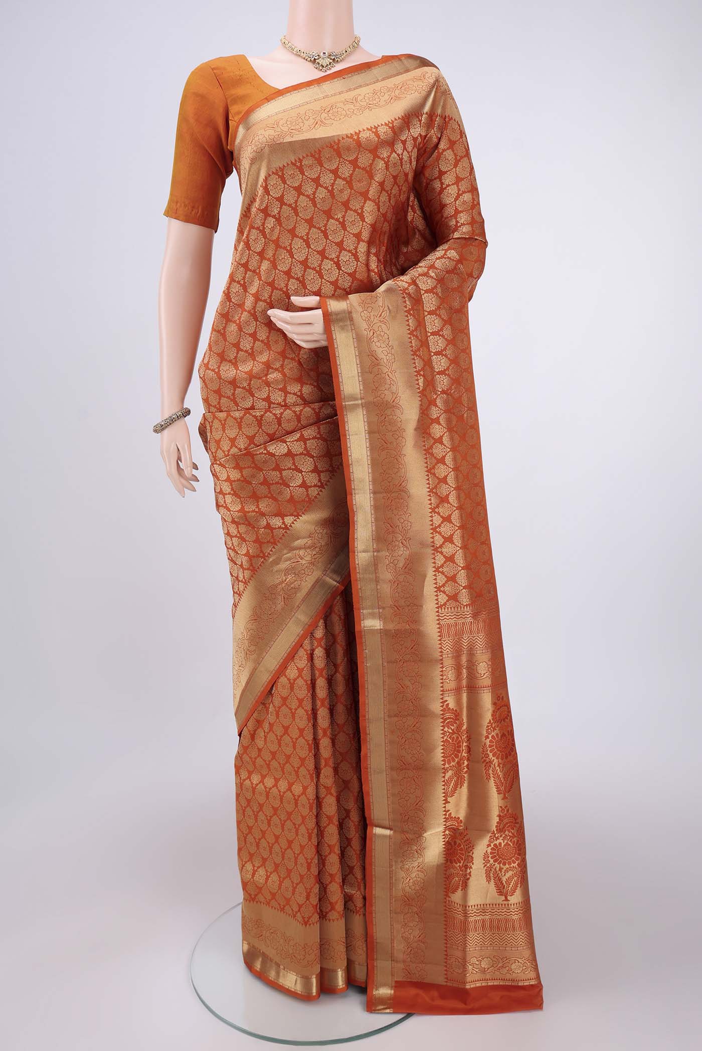 Rust Soft Silk Saree with Zari Brocade on the body and Zari Border.  displayed on a mannequin