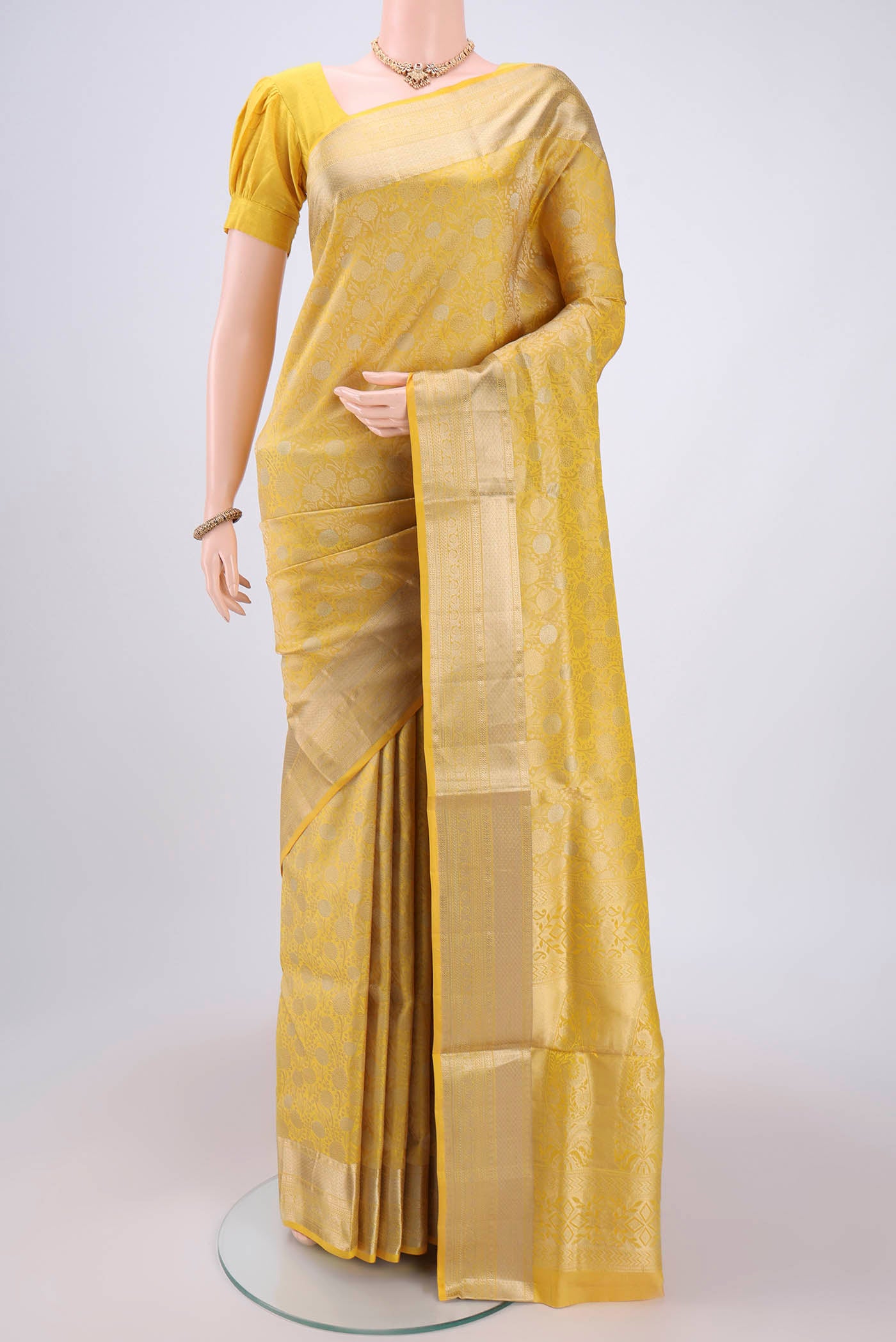Lemon Yellow Soft Silk Saree with Zari Brocade on the body and Zari Border.  displayed on a mannequin