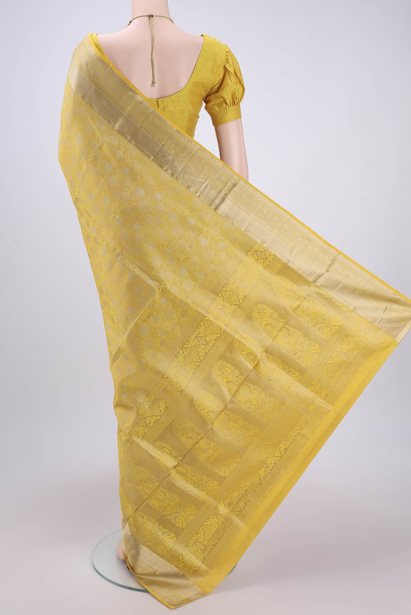 Flat view of Lemon Yellow Soft Silk Saree with Zari Brocade on the body and Zari Border. 