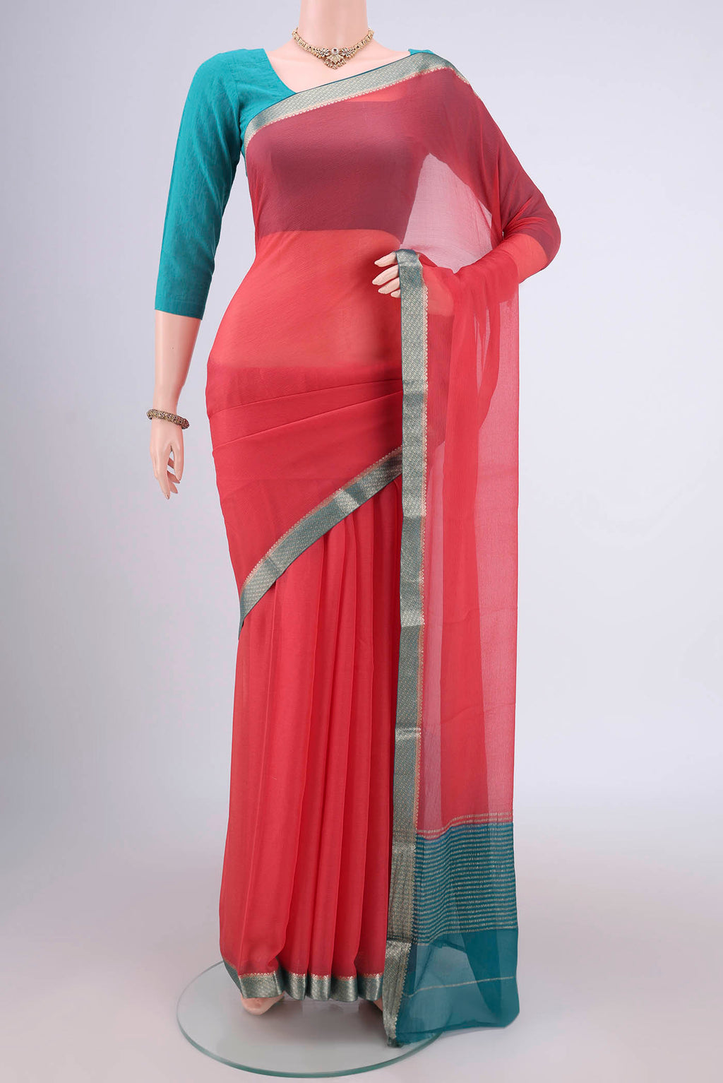 Peach Mysore Chiffon Saree with Plain Body and Zari Border.  displayed on a mannequin