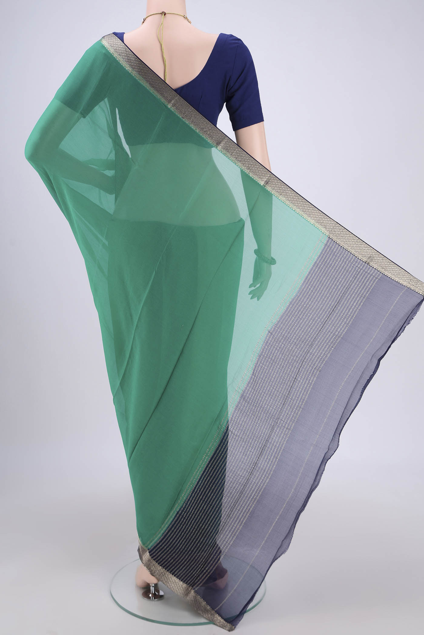 Flat view of Sea Green Dual Tone Mysore Chiffon Saree with Plain Body and Zari Border. 