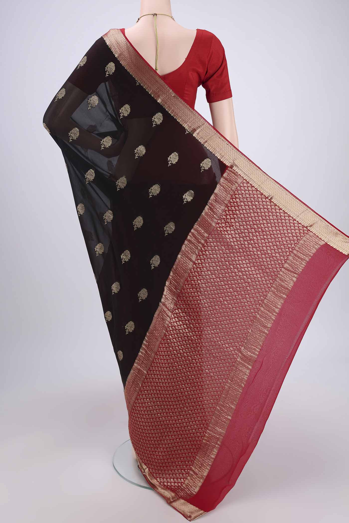 Flat view of Black Dual Tone Mysore Georgette Saree with Zari Butta on the body and Zari Border. 