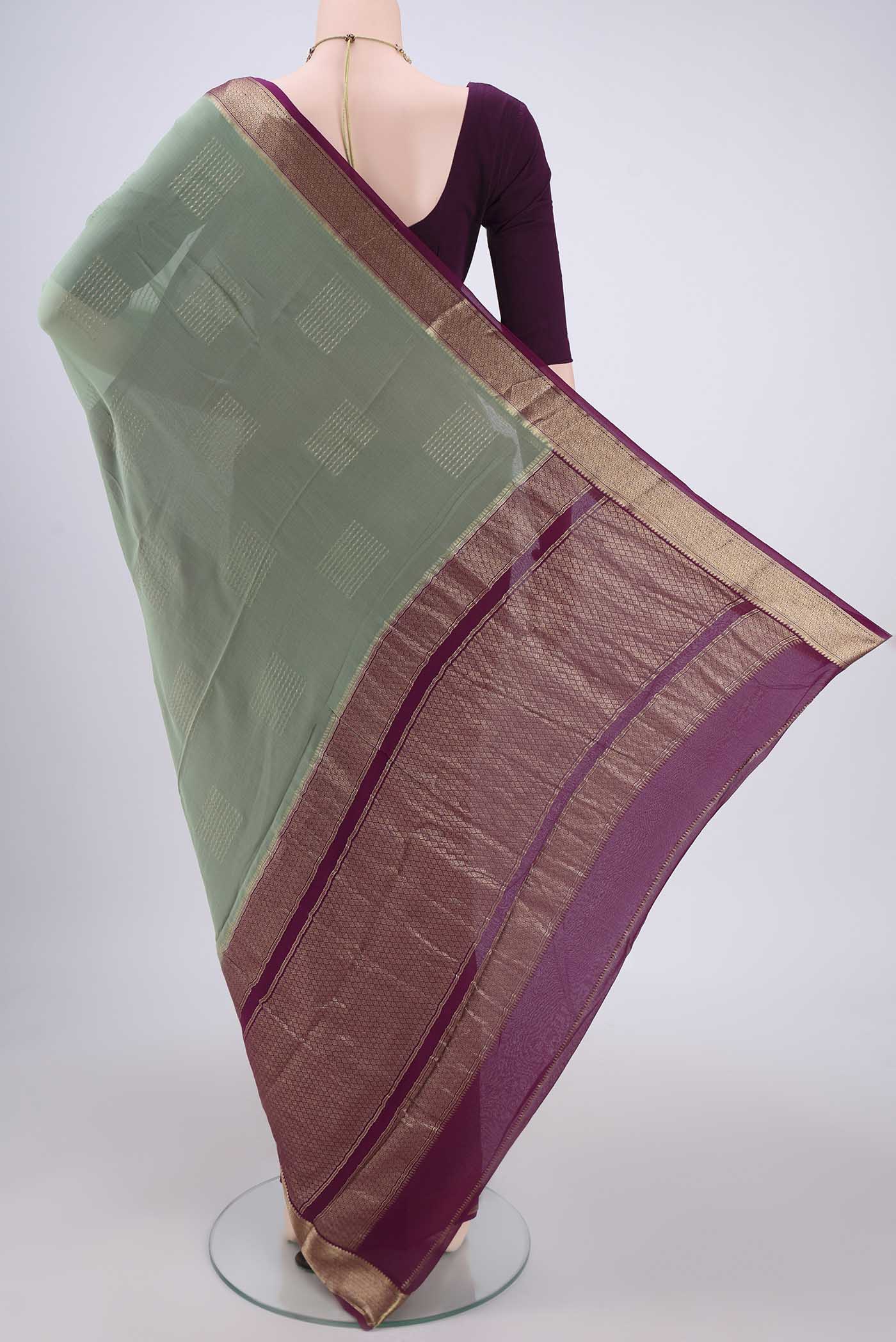 Flat view of Pista Green Georgette Saree with Zari Butta on the body and Zari Border. 
