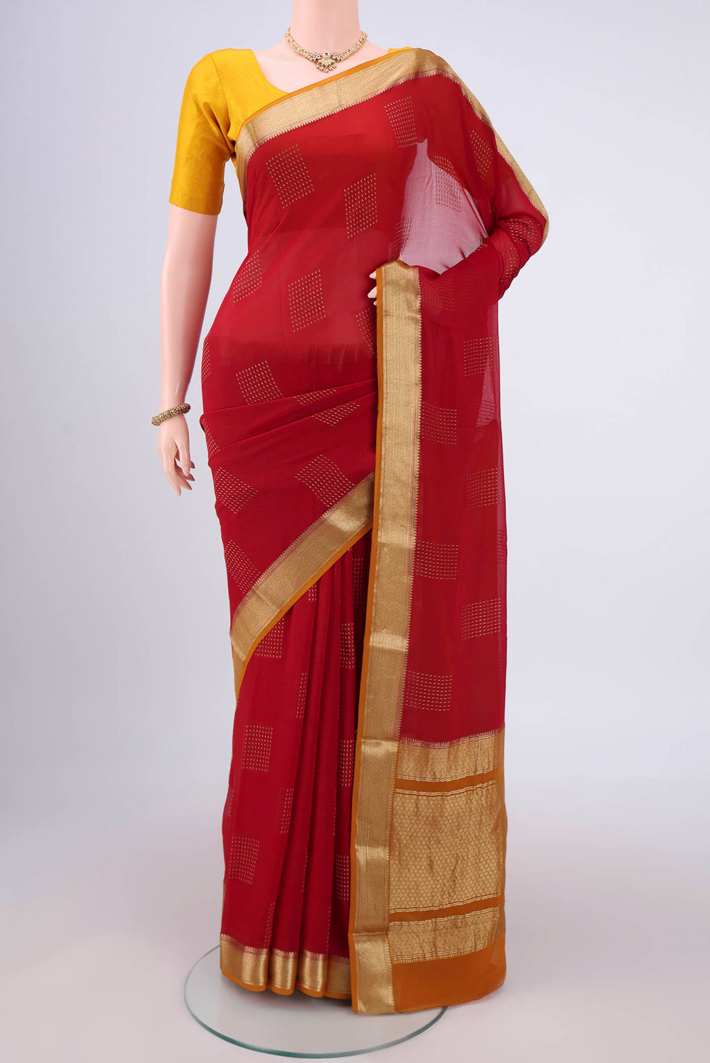 Maroon Mysore Georgette Saree with Zari Butta on the body and Zari Border.  displayed on a mannequin
