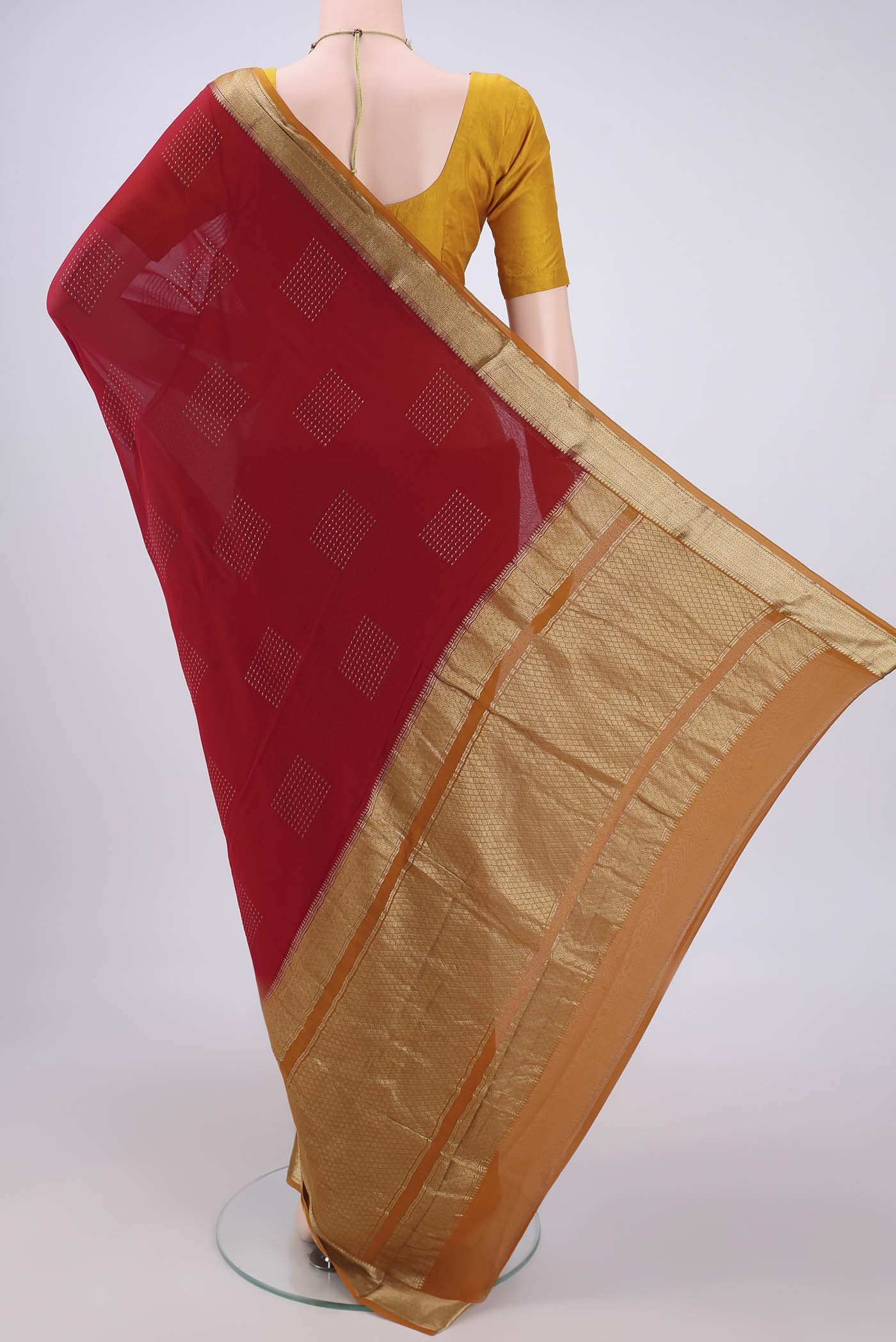 Flat view of Maroon Mysore Georgette Saree with Zari Butta on the body and Zari Border. 