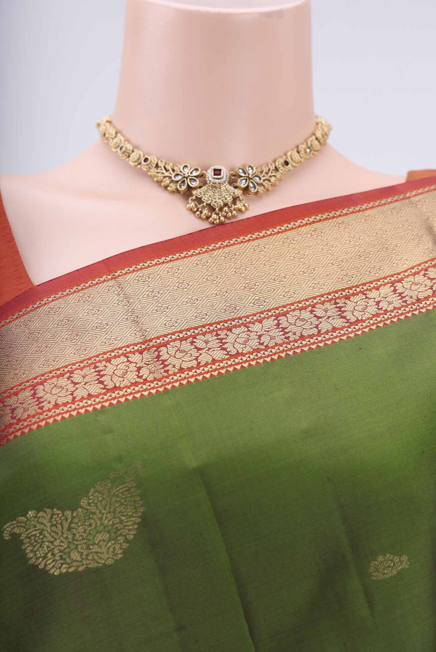 Border image of Green Kanchipuram Silk Saree with Zari Butta on the body and Zari Border. 