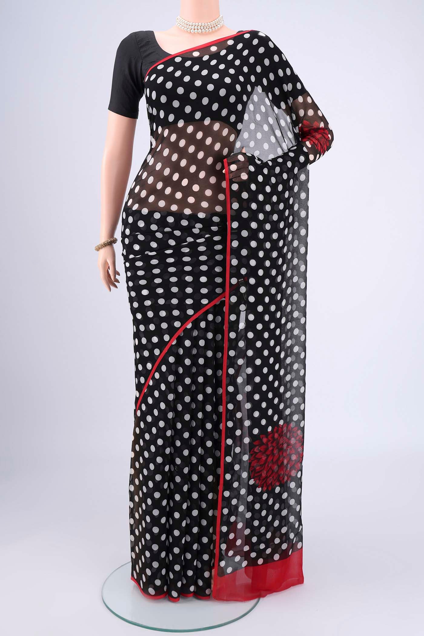 Black Mysore Chiffon Saree with Polka Dots on the body and Plain Border.  displayed on a mannequin
