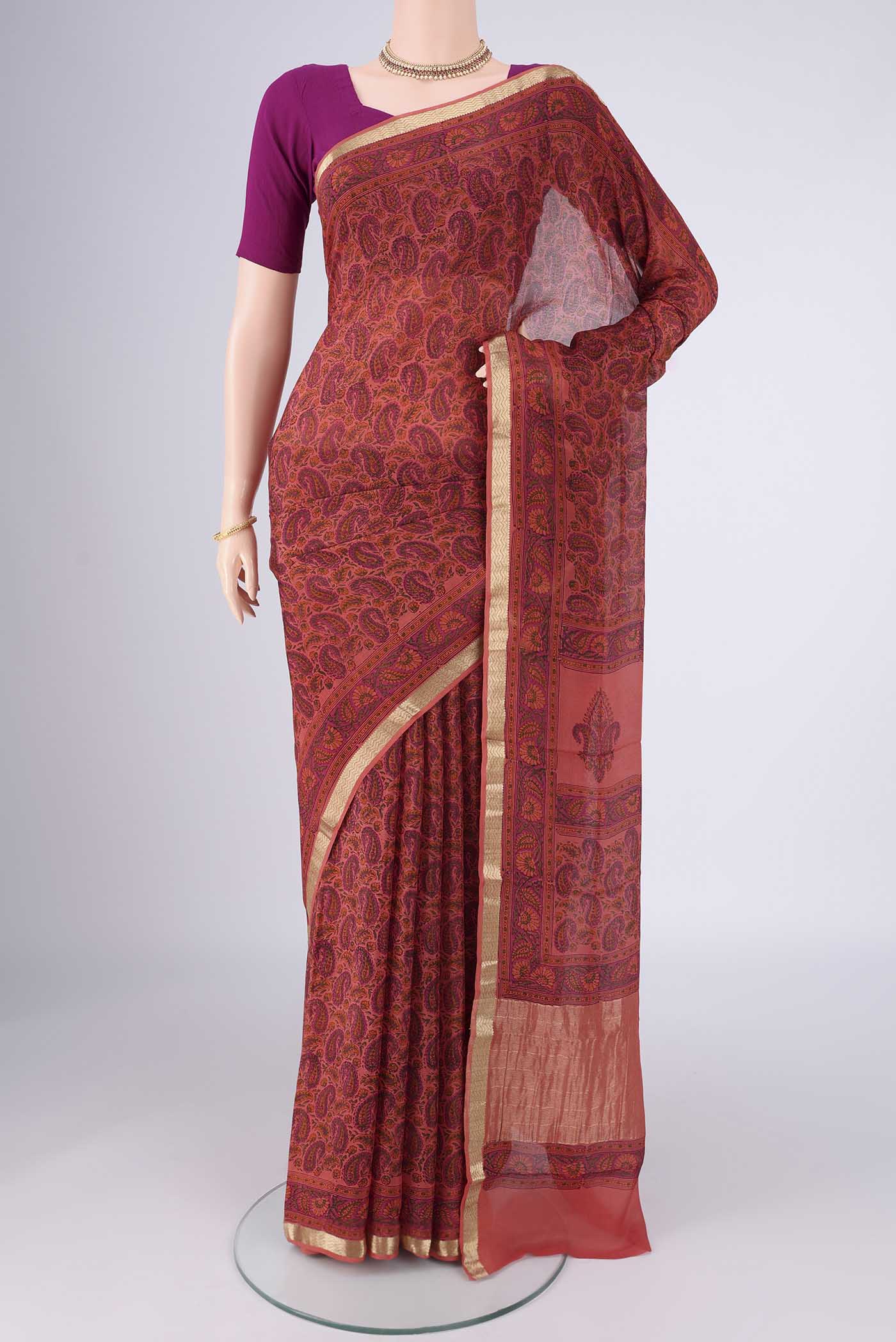 Coral Mysore Crepe Saree with Printed design on the body and Zari Border.  displayed on a mannequin