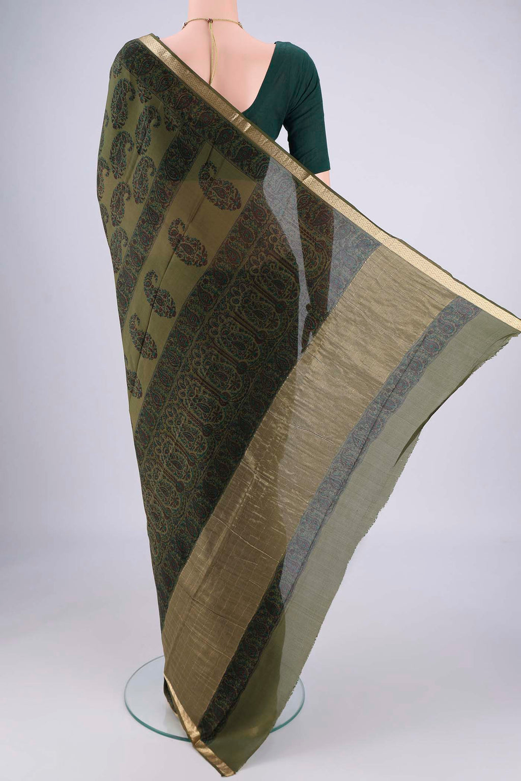 Flat view of Olive Green Mysore Crepe Saree with Printed design on the body and Zari Border. 
