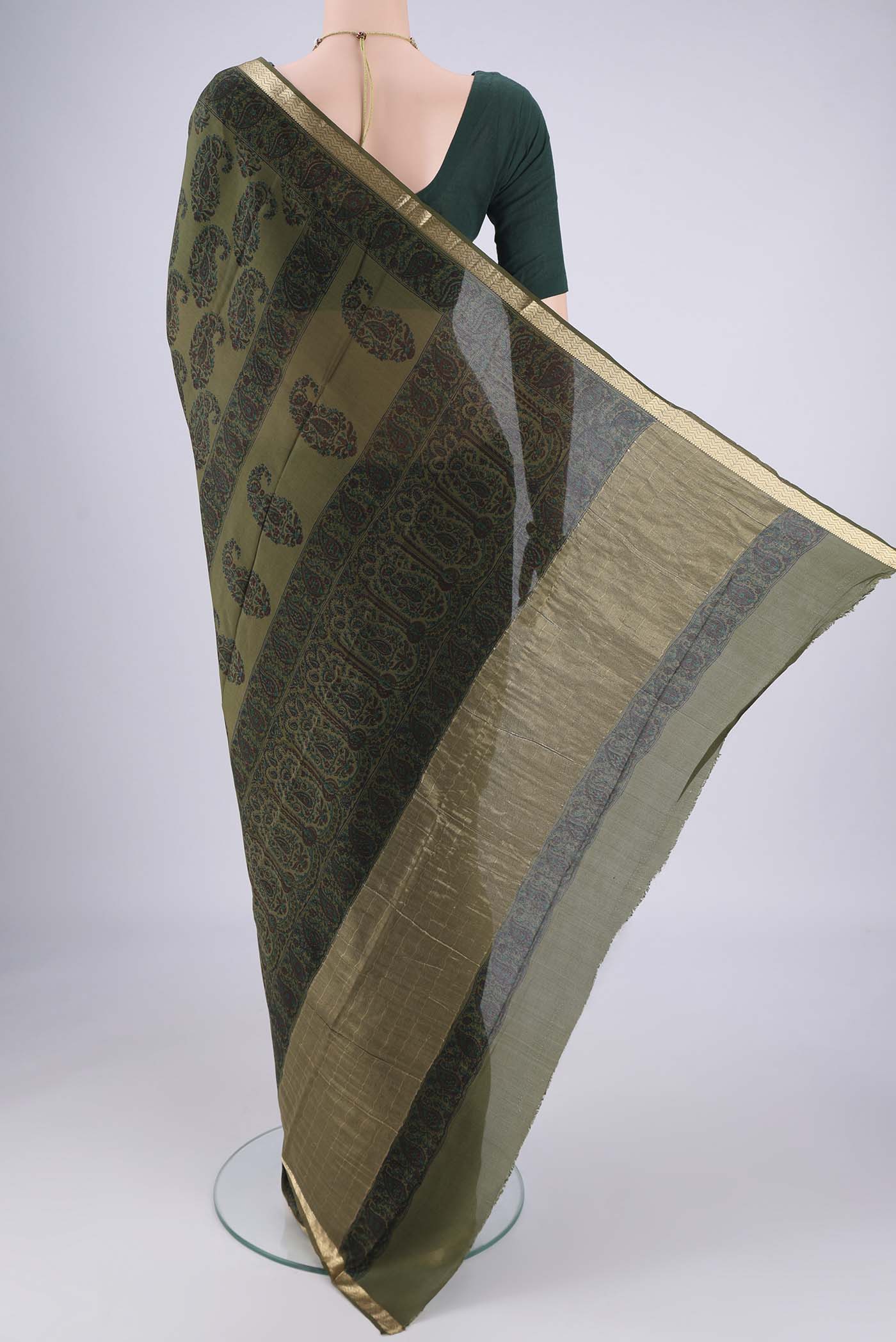 Flat view of Olive Green Mysore Crepe Saree with Printed design on the body and Zari Border. 