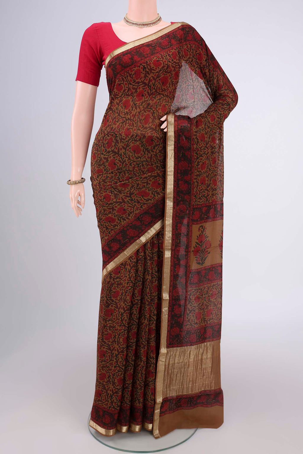 Dark Beige Mysore Crepe Saree with Floral Print on the body and Zari Border.  displayed on a mannequin