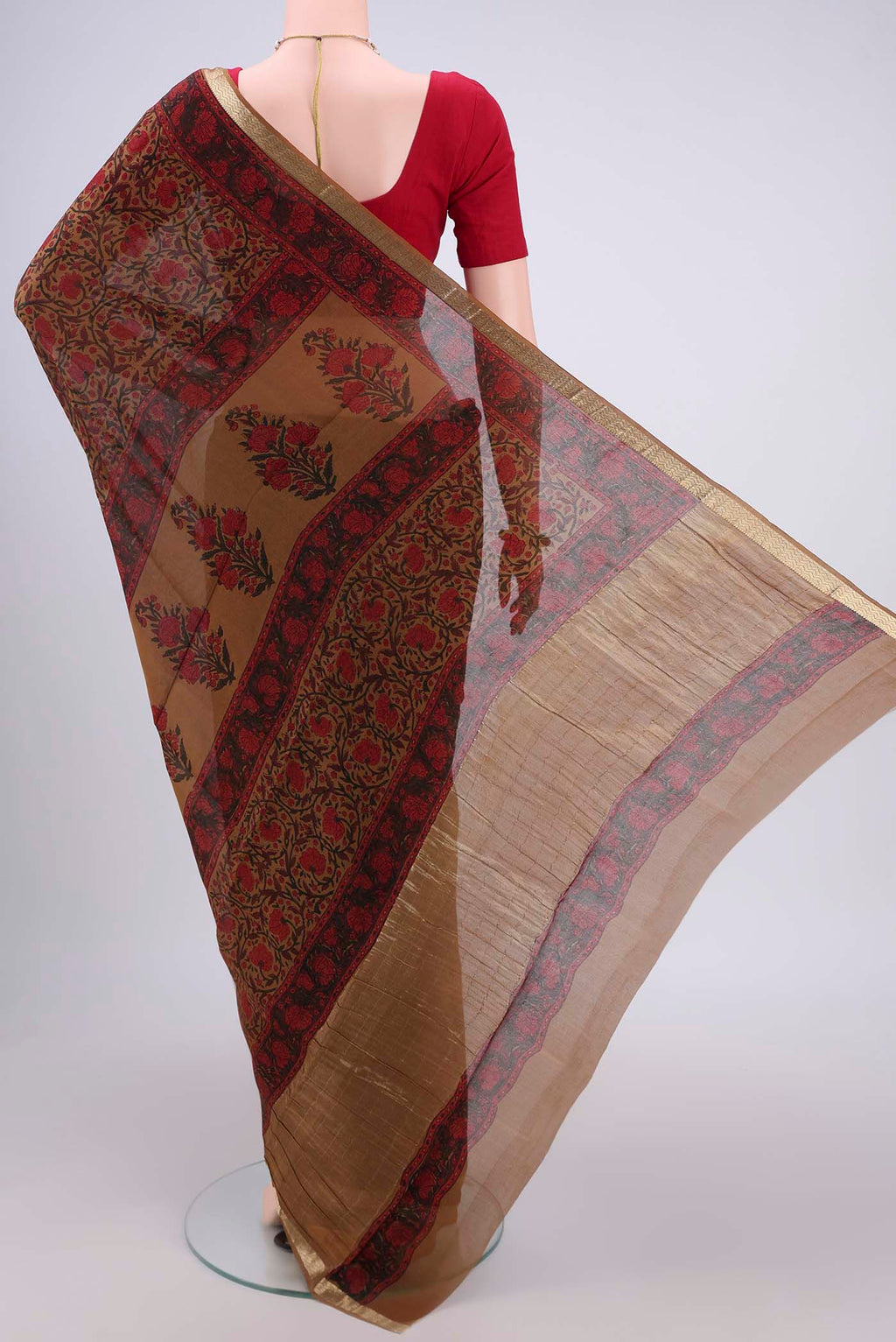 Flat view of Dark Beige Mysore Crepe Saree with Floral Print on the body and Zari Border. 