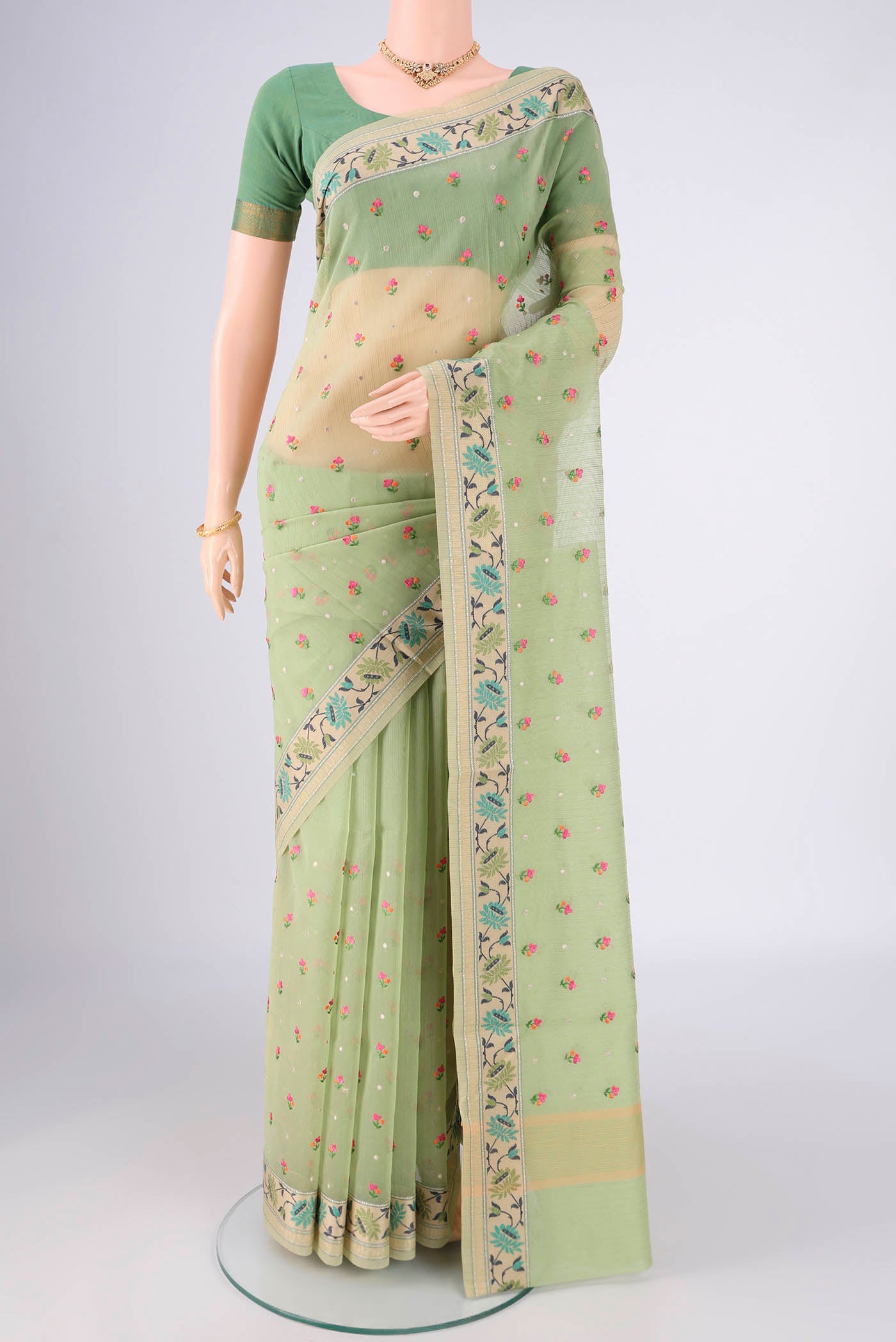 Light Green Blended Kota Cotton Saree with Embroidery on the body and Embroidery Border.  displayed on a mannequin