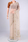 Beige Blended Kota Cotton Saree with Embroidery on the body and Thread Border.  displayed on a mannequin