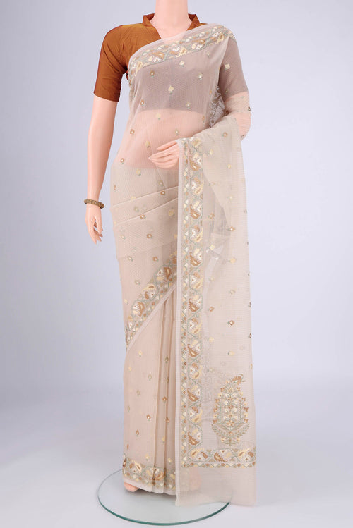 Beige Blended Kota Cotton Saree with Embroidery on the body and Thread Border.  displayed on a mannequin