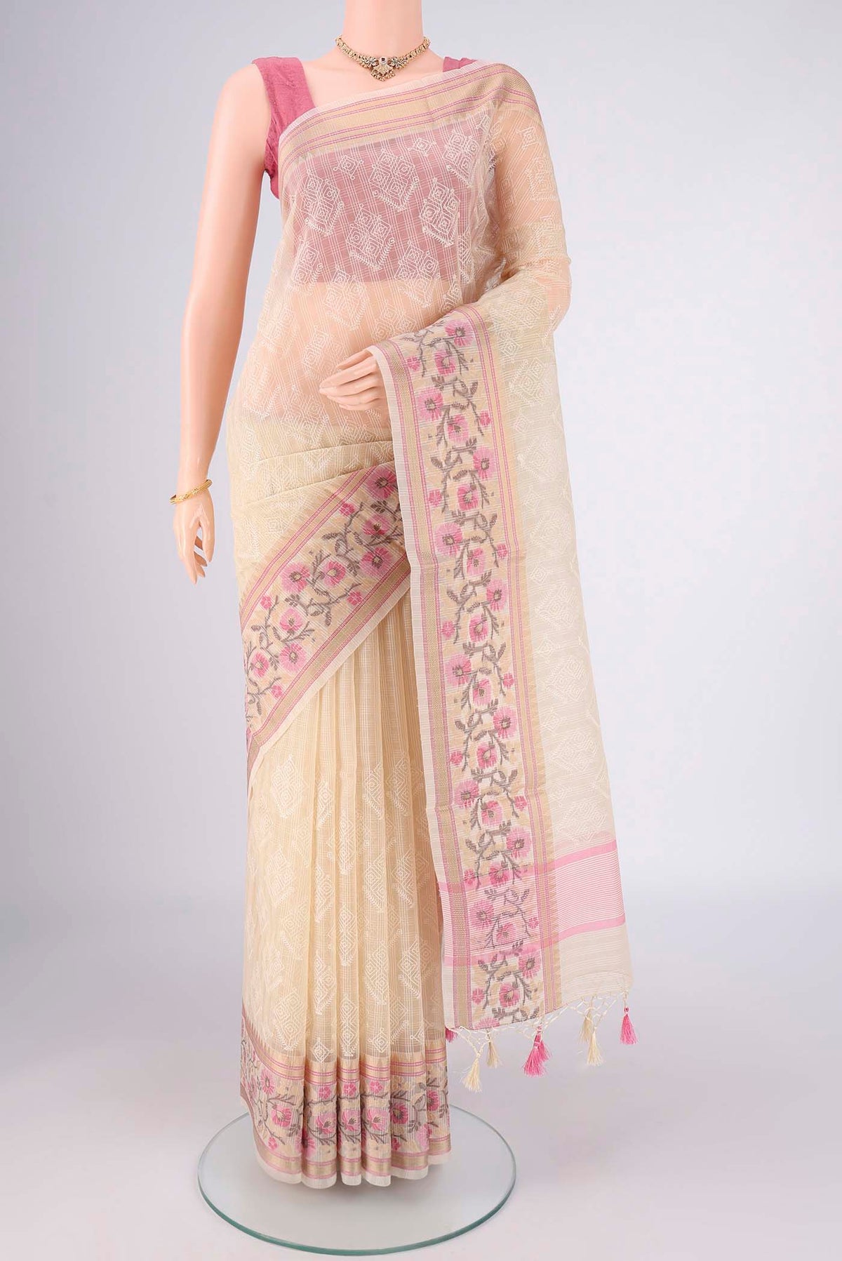 Cream Blended Kota Cotton Saree with Embroidery on the body and Thread Border.  displayed on a mannequin