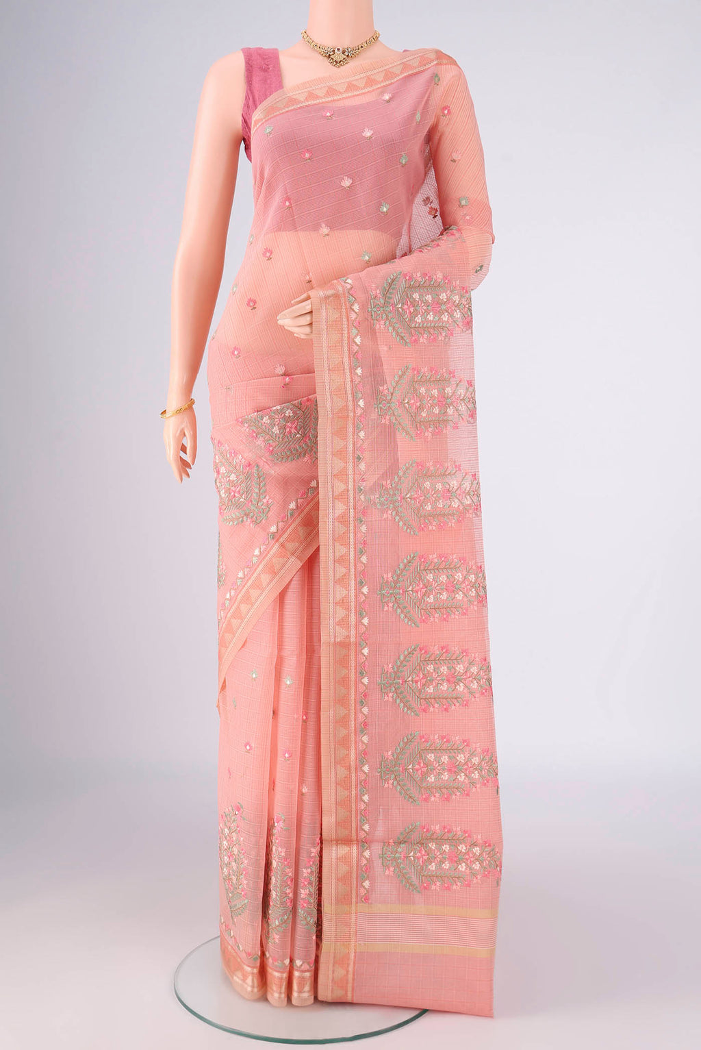 Peach Blended Kota Cotton Saree with Embroidery on the body and Thread Border.  displayed on a mannequin