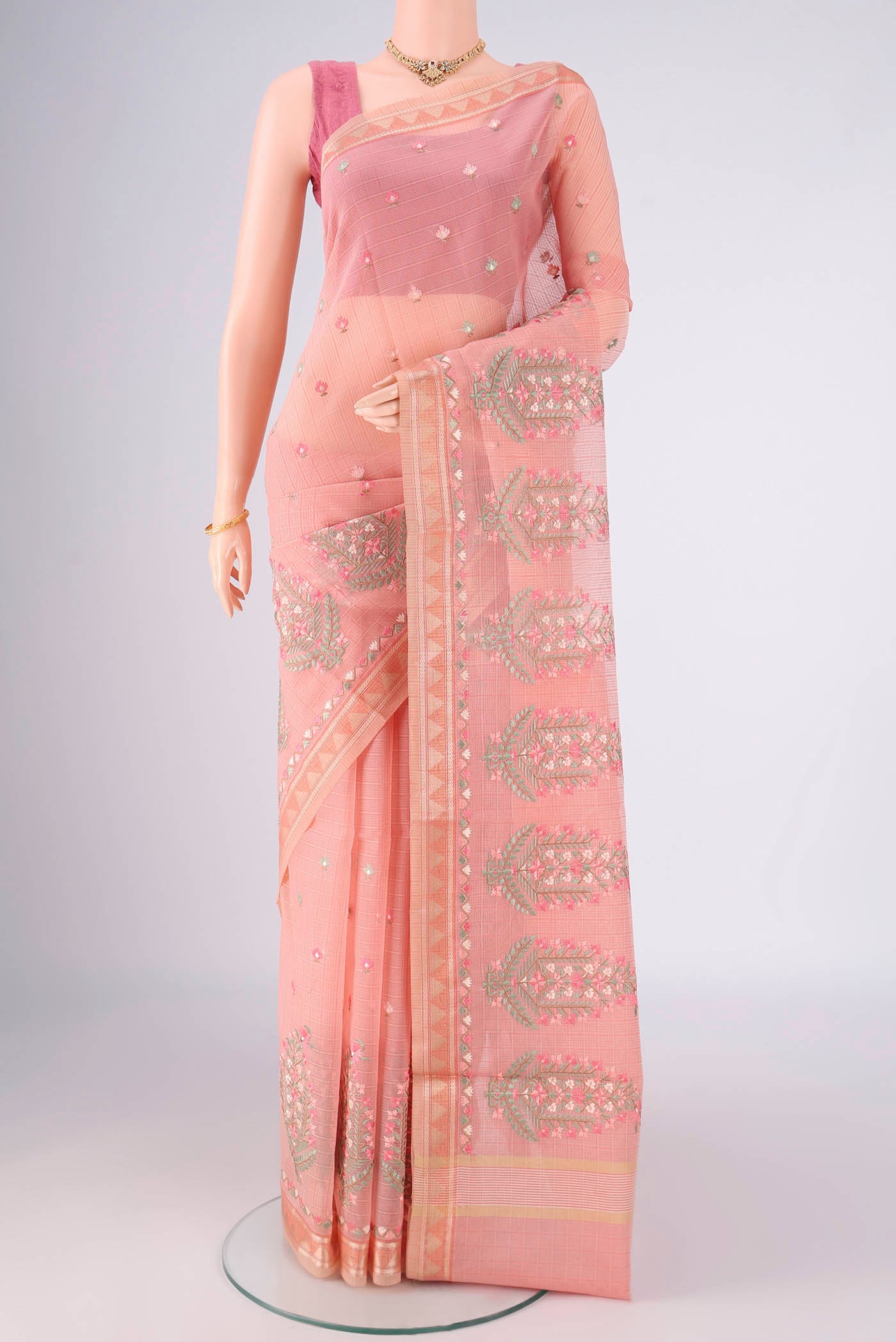 Peach Blended Kota Cotton Saree with Embroidery on the body and Thread Border.  displayed on a mannequin