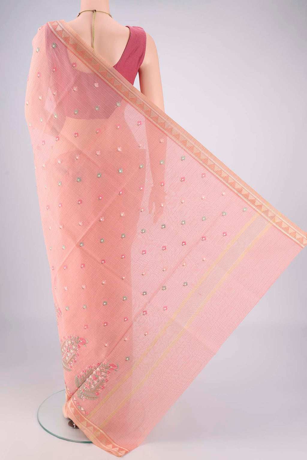 Flat view of Peach Blended Kota Cotton Saree with Embroidery on the body and Thread Border. 