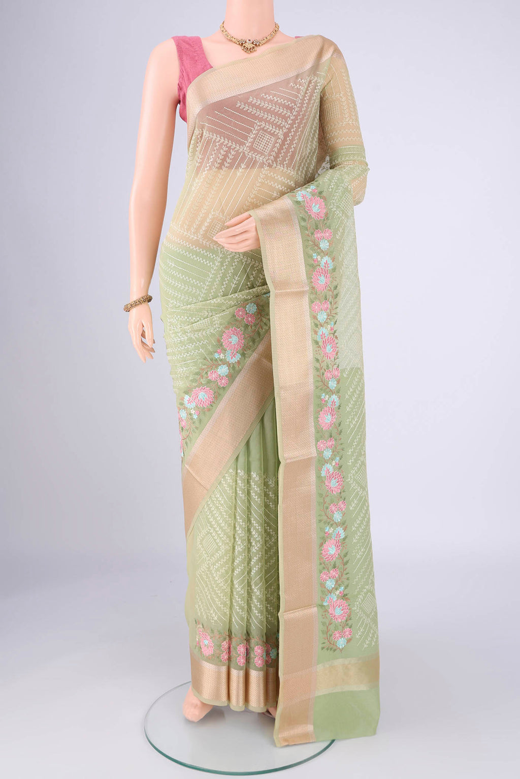 Light Green Blended Kota Cotton Saree with Embroidery on the body and Zari Border.  displayed on a mannequin