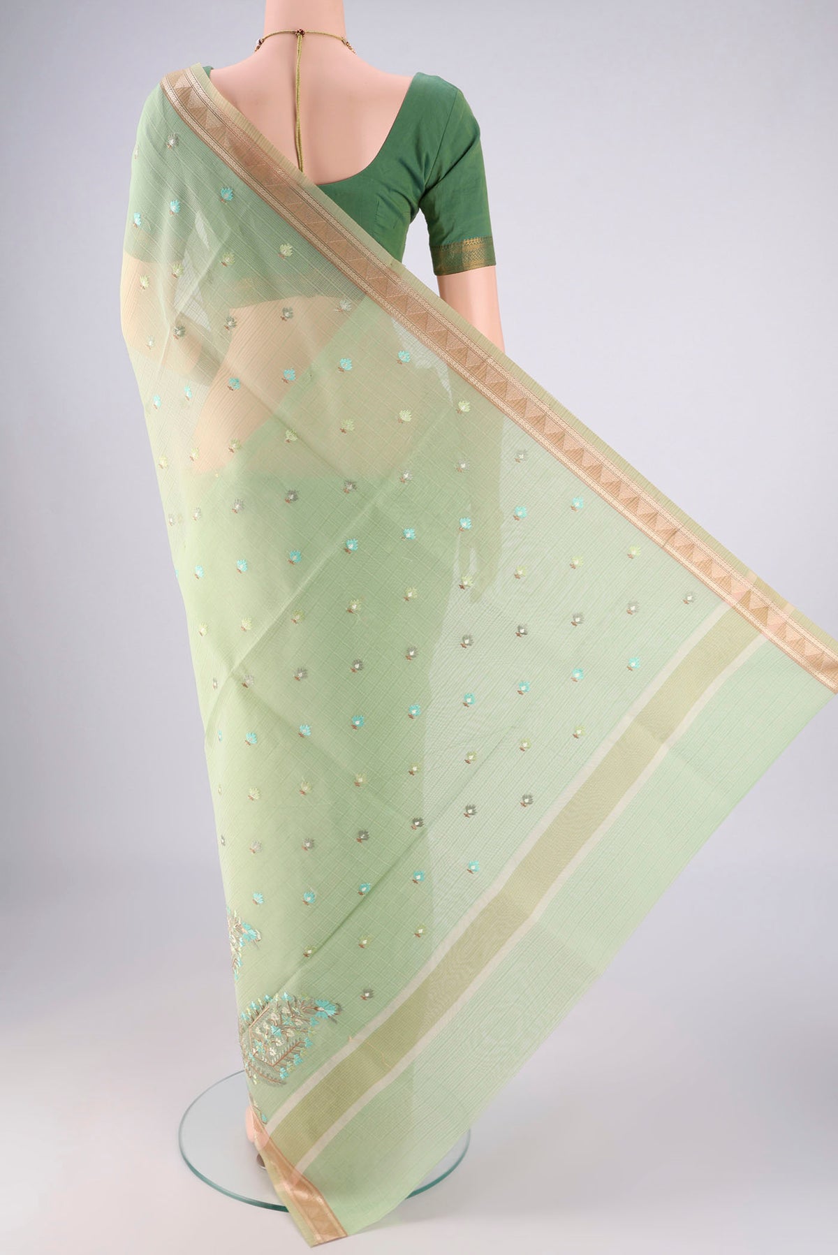 Flat view of Light Green Blended Kota Cotton Saree with Embroidery on the body and Zari Border. 