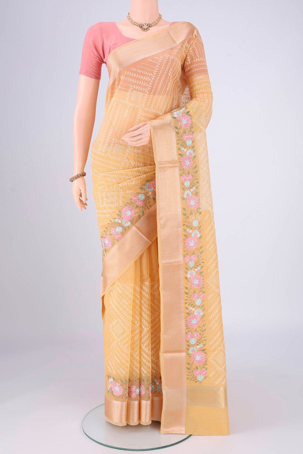 Lemon Yellow Blended Kota Cotton Saree with Embroidery on the body and Zari Border.  displayed on a mannequin