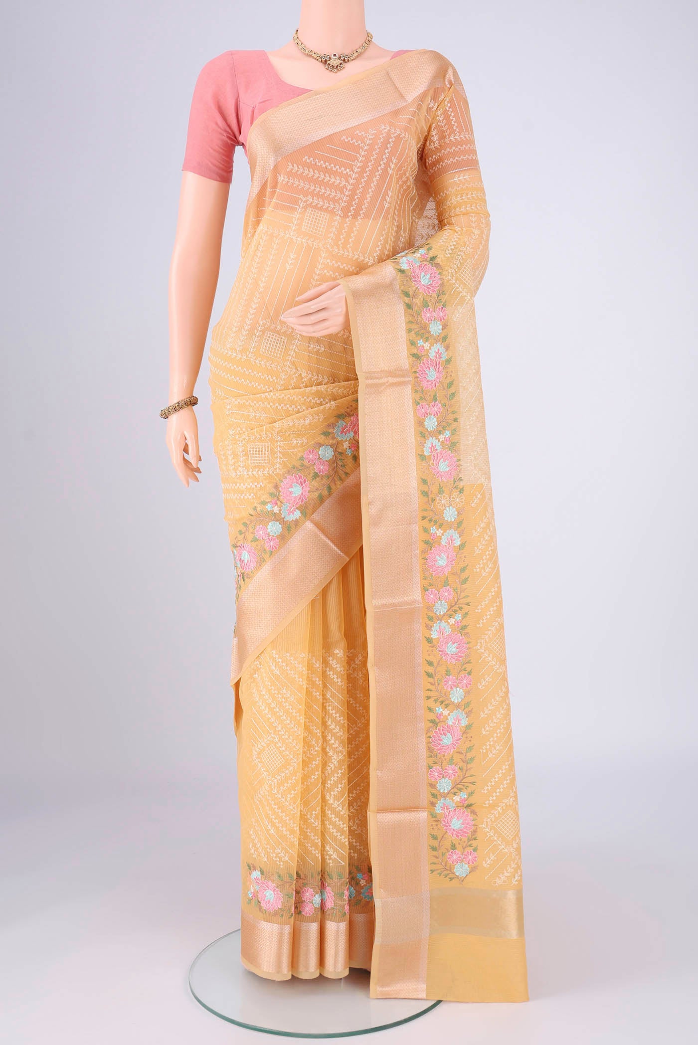 Lemon Yellow Blended Kota Cotton Saree with Embroidery on the body and Zari Border.  displayed on a mannequin