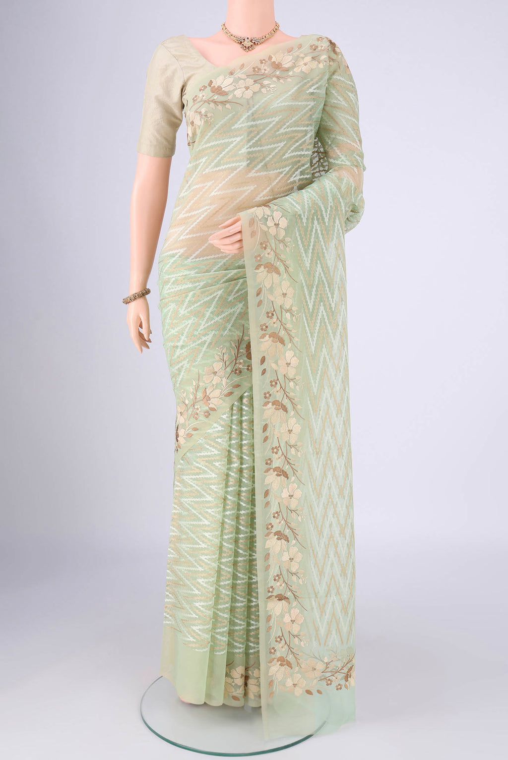 Pista Green Blended Kota Cotton Saree with Embroidery on the body and Thread Border.  displayed on a mannequin