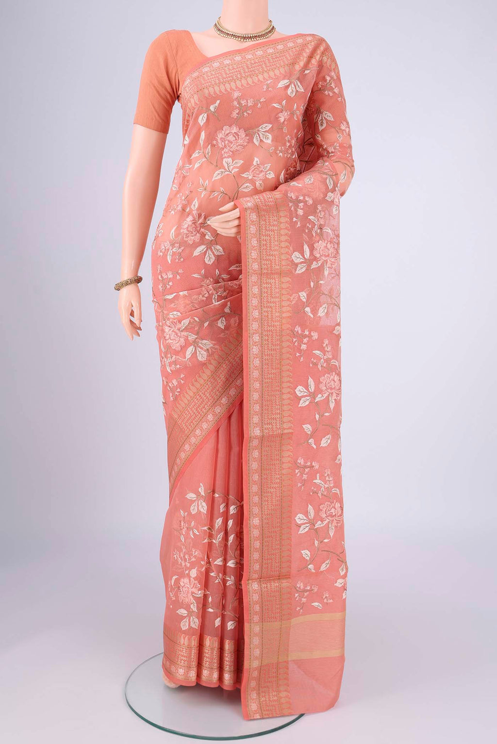 Peach Blended Kota Cotton Saree with Embroidery on the body and Thread Border.  displayed on a mannequin