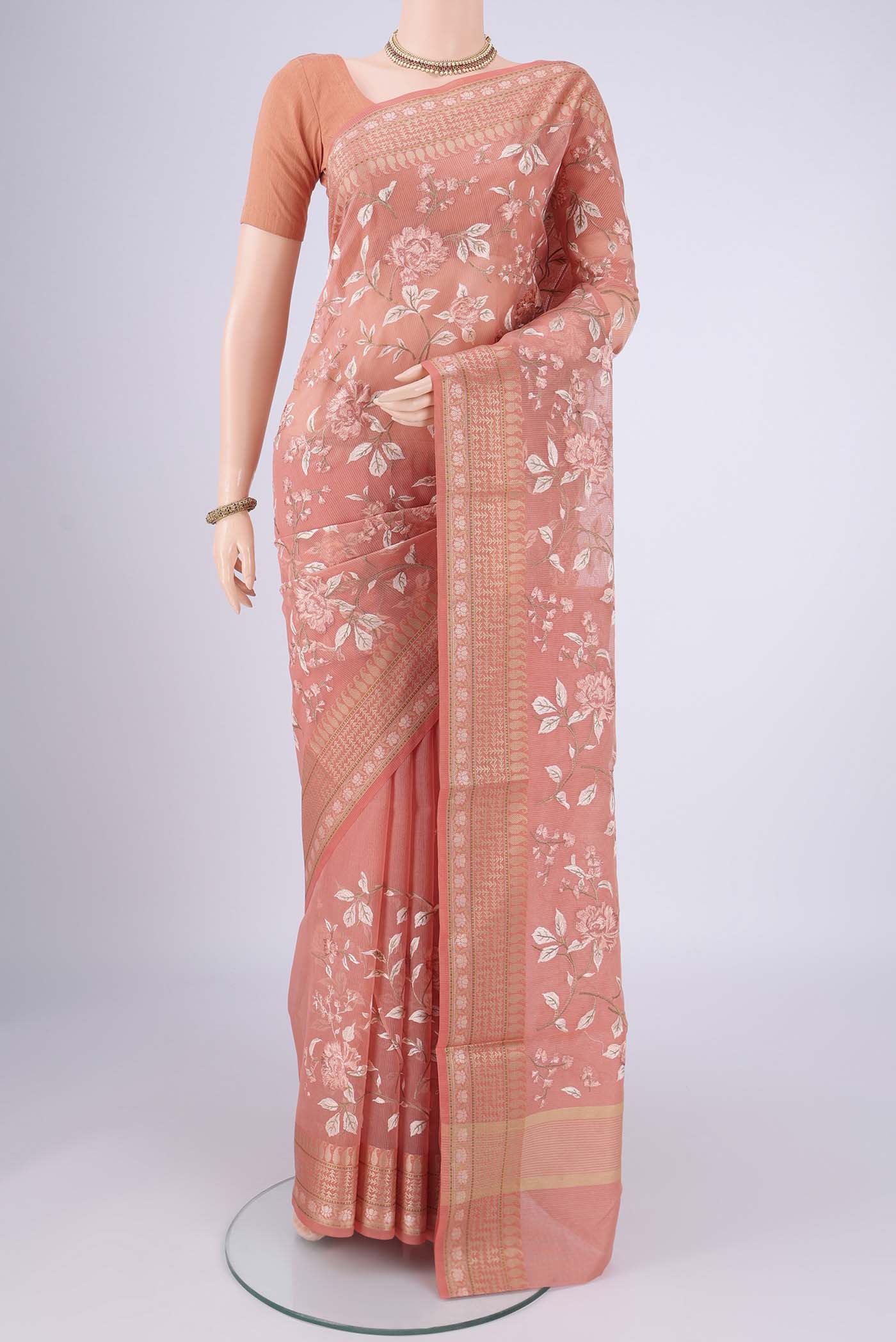 Peach Blended Kota Cotton Saree with Embroidery on the body and Thread Border.  displayed on a mannequin