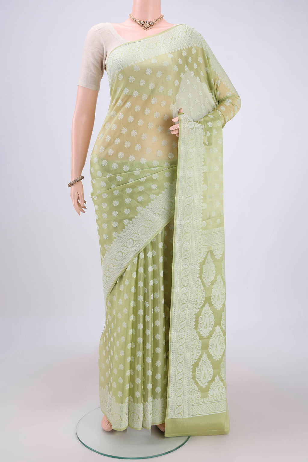 Pista Green Blended Banarasi Georgette Saree with Thread Butta on the body and Thread Border.  displayed on a mannequin