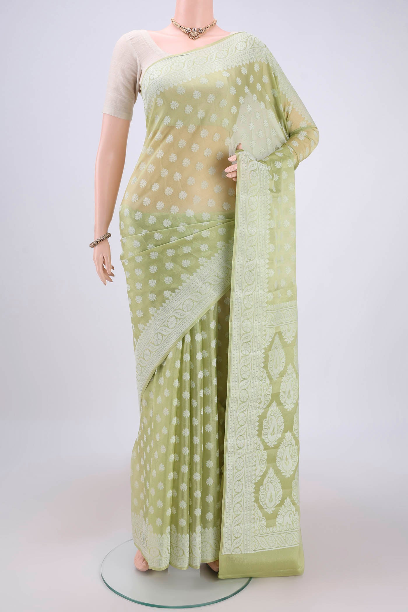 Pista Green Blended Banarasi Georgette Saree with Thread Butta on the body and Thread Border.  displayed on a mannequin