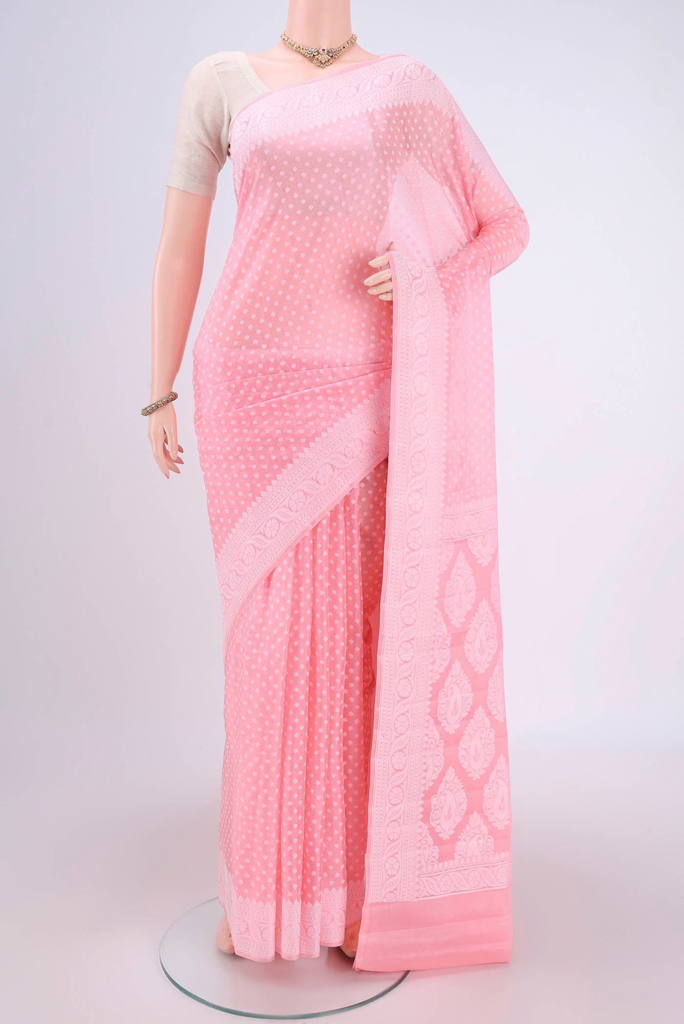Peach Blended Banarasi Georgette Saree with Thread Butta on the body and Thread Border.  displayed on a mannequin