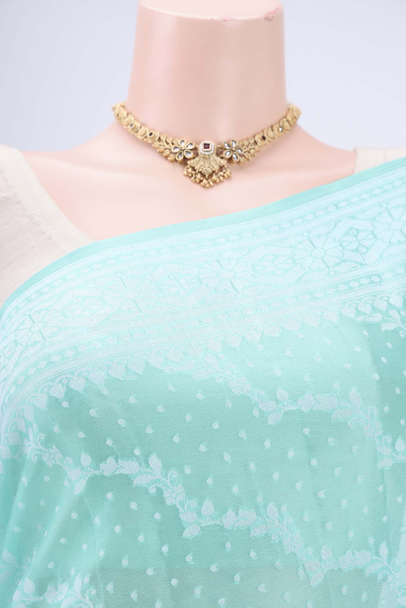 Border image of Turquoise Blended Banarasi Georgette Saree with Thread Brocade on the body and Zari Border. 