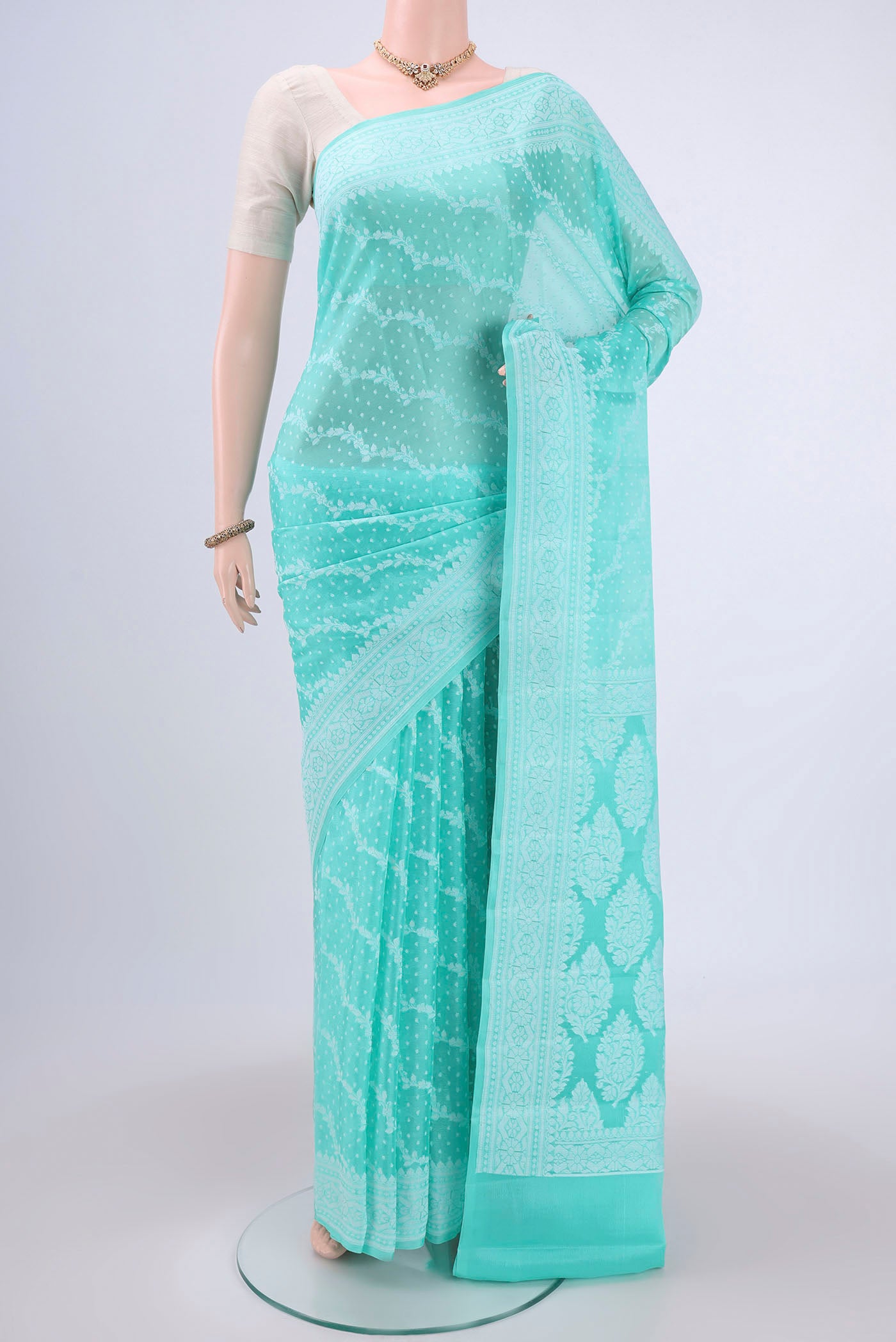 Turquoise Blended Banarasi Georgette Saree with Thread Brocade on the body and Zari Border.  displayed on a mannequin