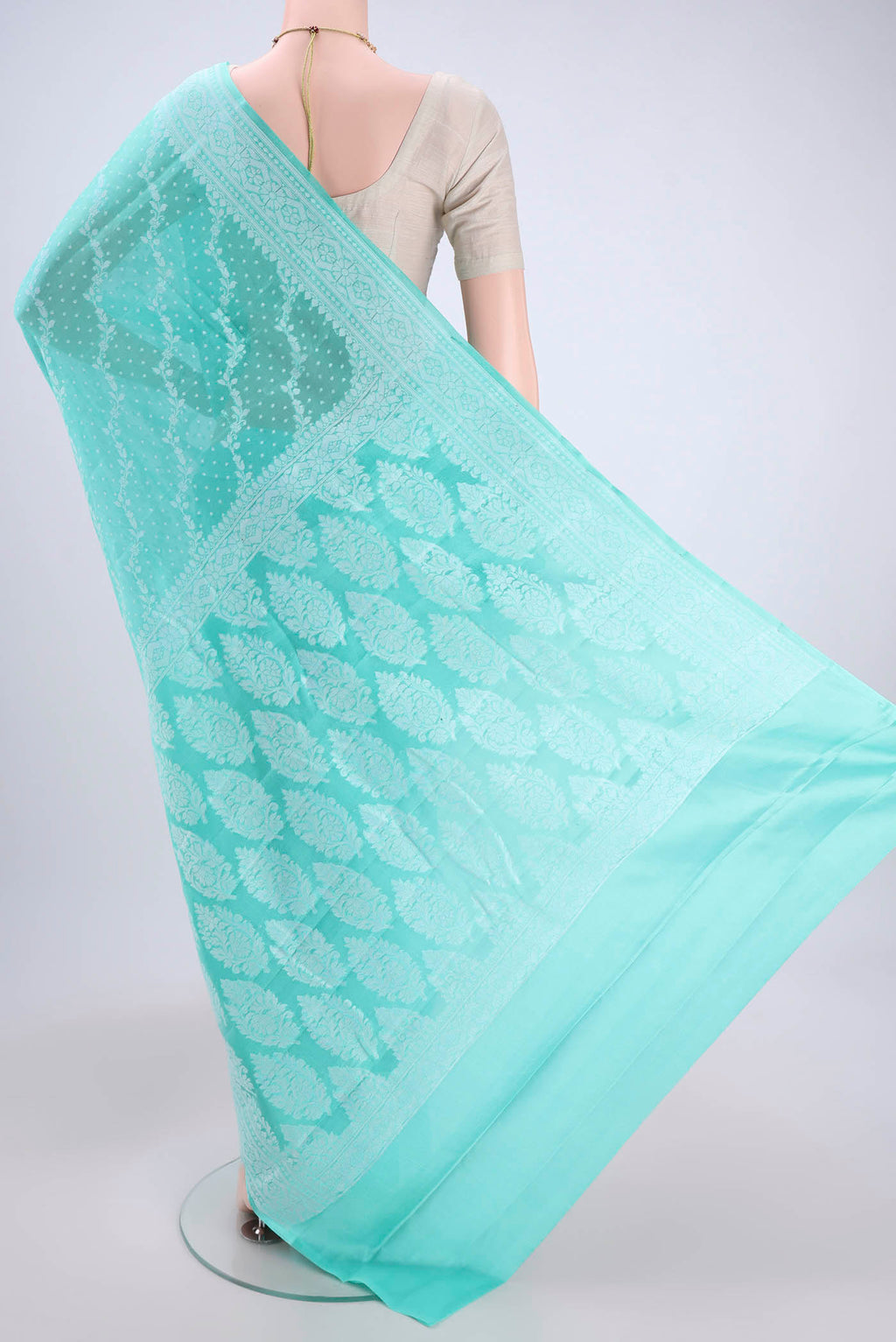 Flat view of Turquoise Blended Banarasi Georgette Saree with Thread Brocade on the body and Zari Border. 