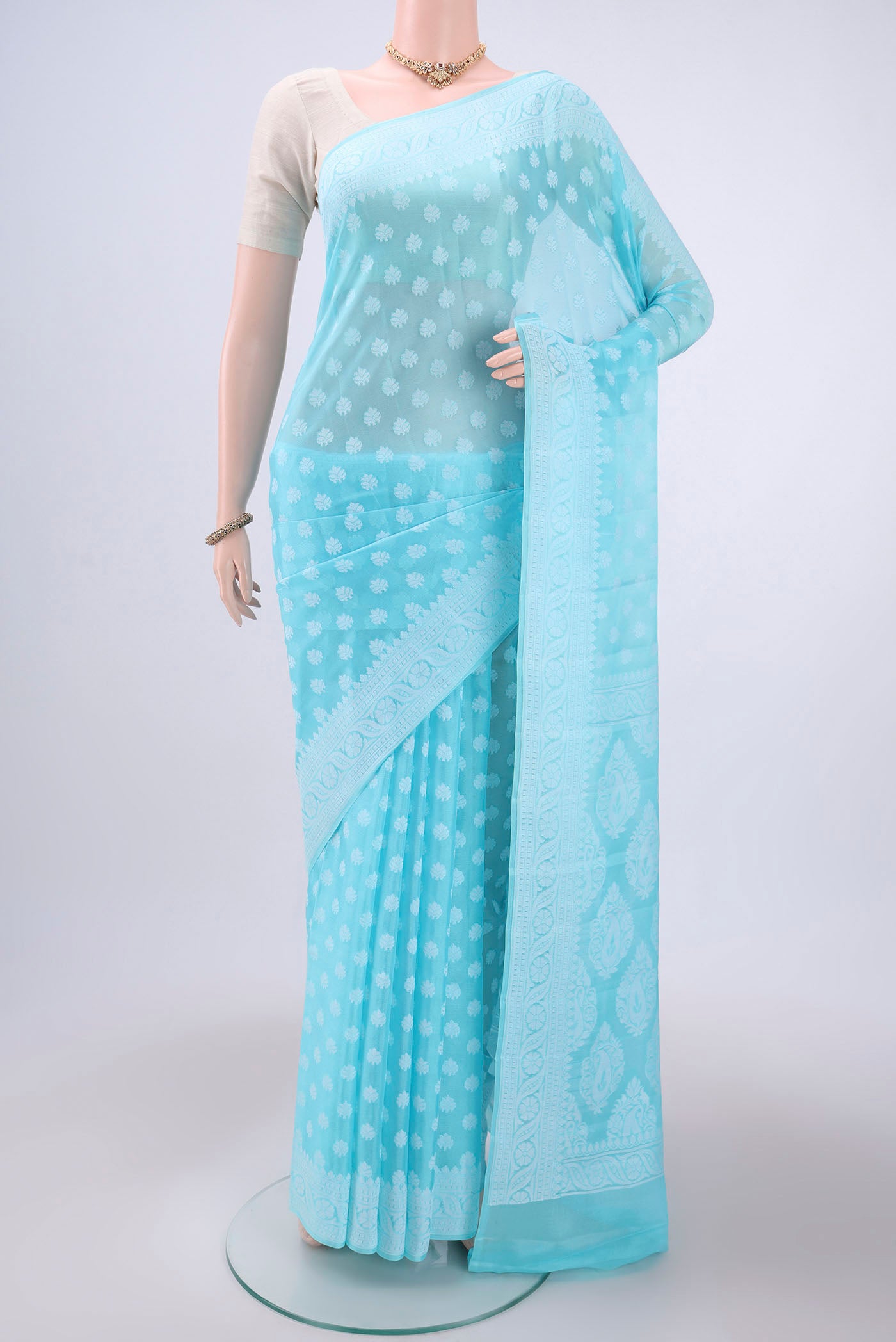 Sky Blue Blended Banarasi Georgette Saree with Thread Butta on the body and Thread Border.  displayed on a mannequin