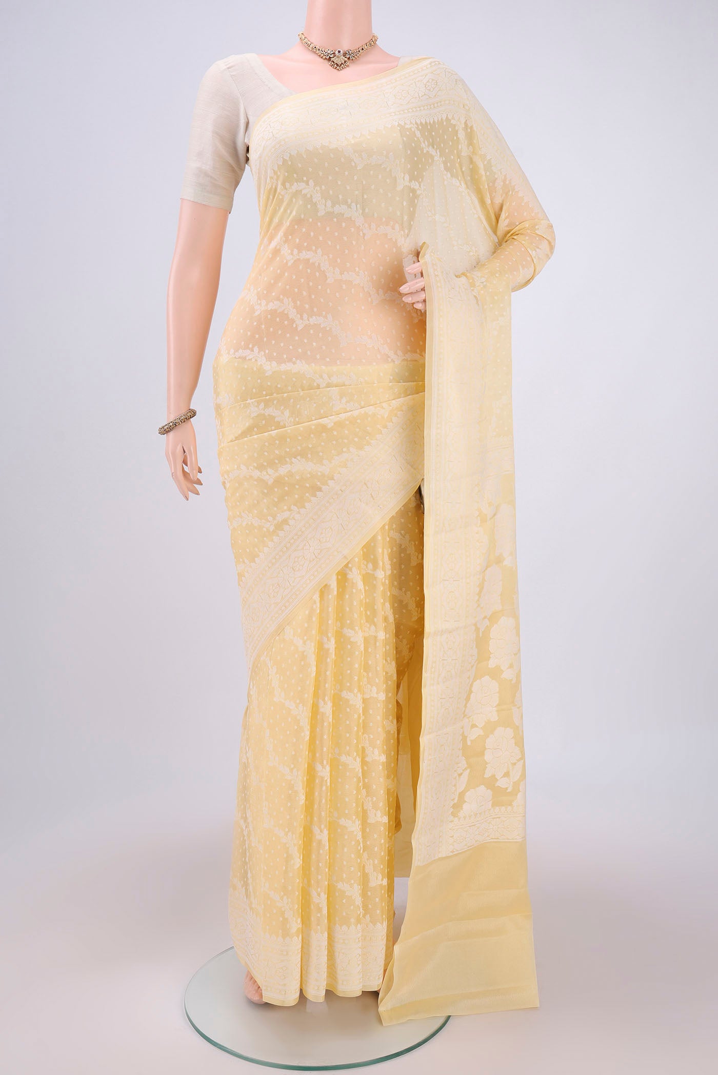 Lemon Yellow Blended Banarasi Georgette Saree with Thread Brocade on the body and Zari Border.  displayed on a mannequin