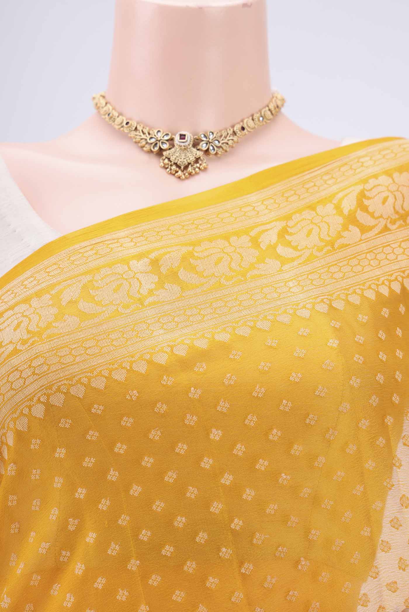 Border image of Mustard Blended Banarasi Georgette Saree with Thread Butta on the body and Thread Border. 