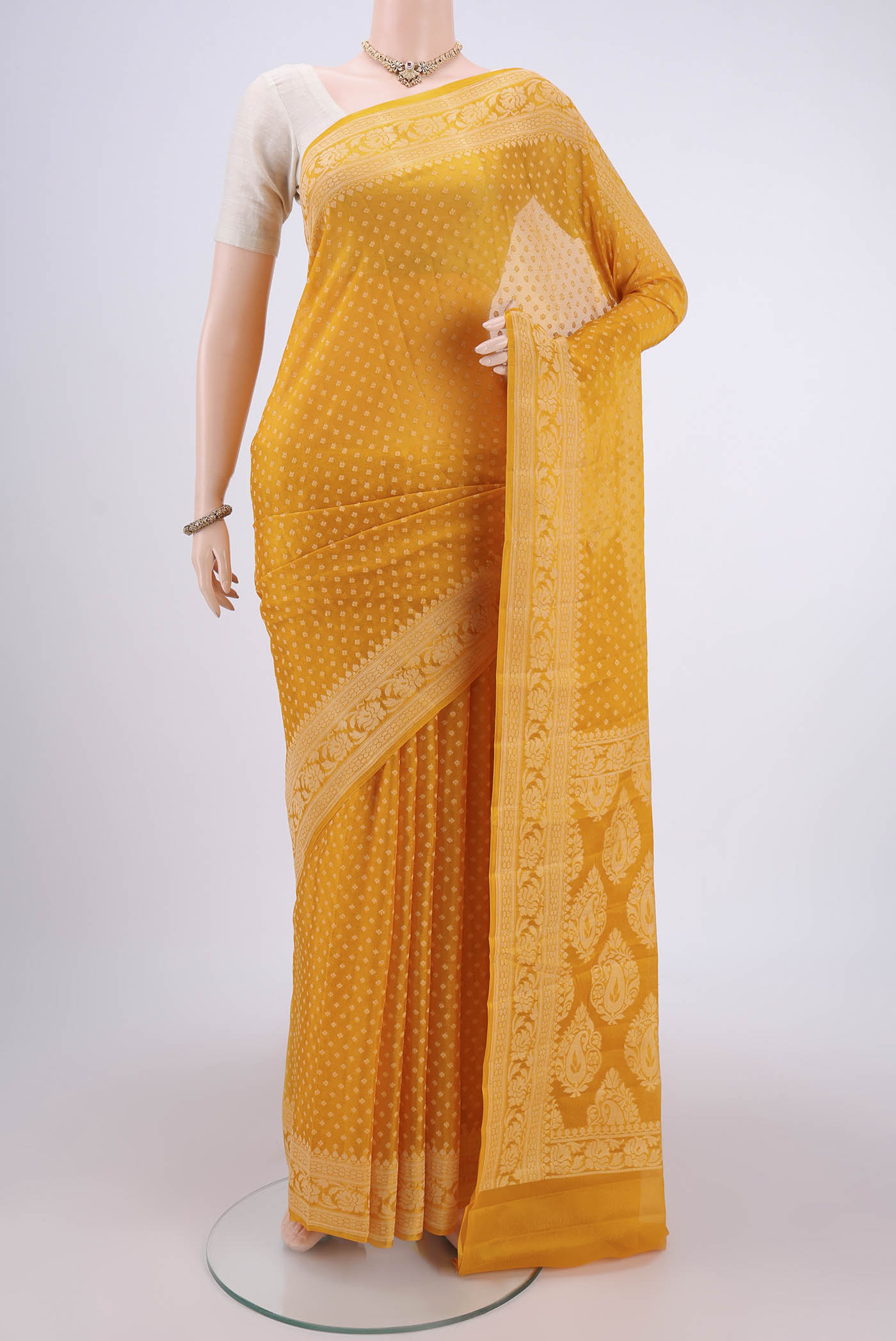 Mustard Blended Banarasi Georgette Saree with Thread Butta on the body and Thread Border.  displayed on a mannequin