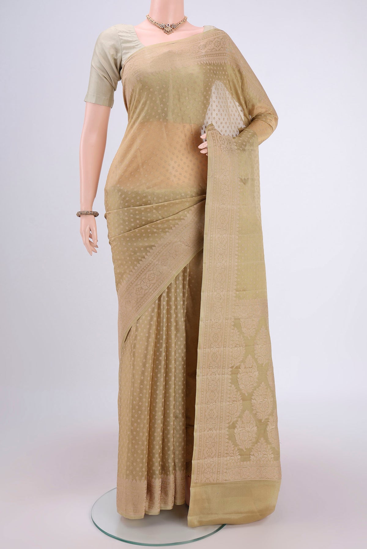 Beige Blended Banarasi Georgette Saree with Thread Butta on the body and Thread Border.  displayed on a mannequin