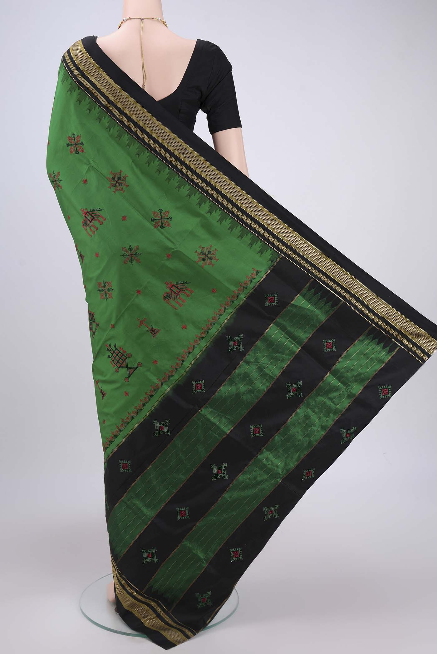 Flat view of Green Bangalore Silk Saree with Embroidery on the body and Temple Border. 
