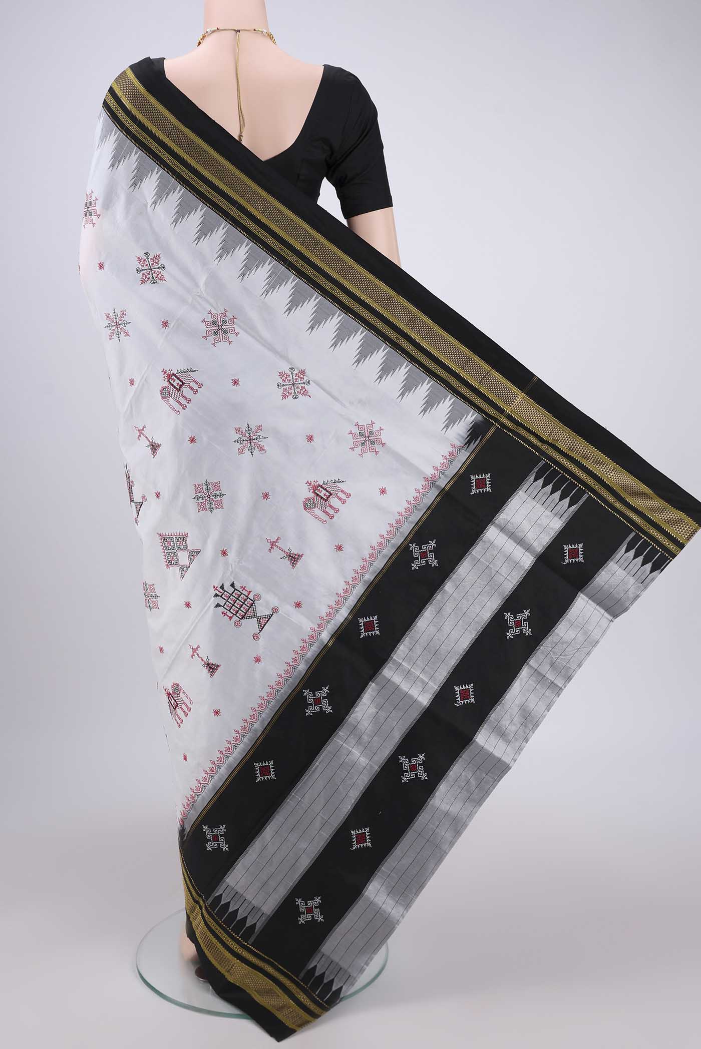 Flat view of White Bangalore Silk Saree with Embroidery on the body and Temple Border. 