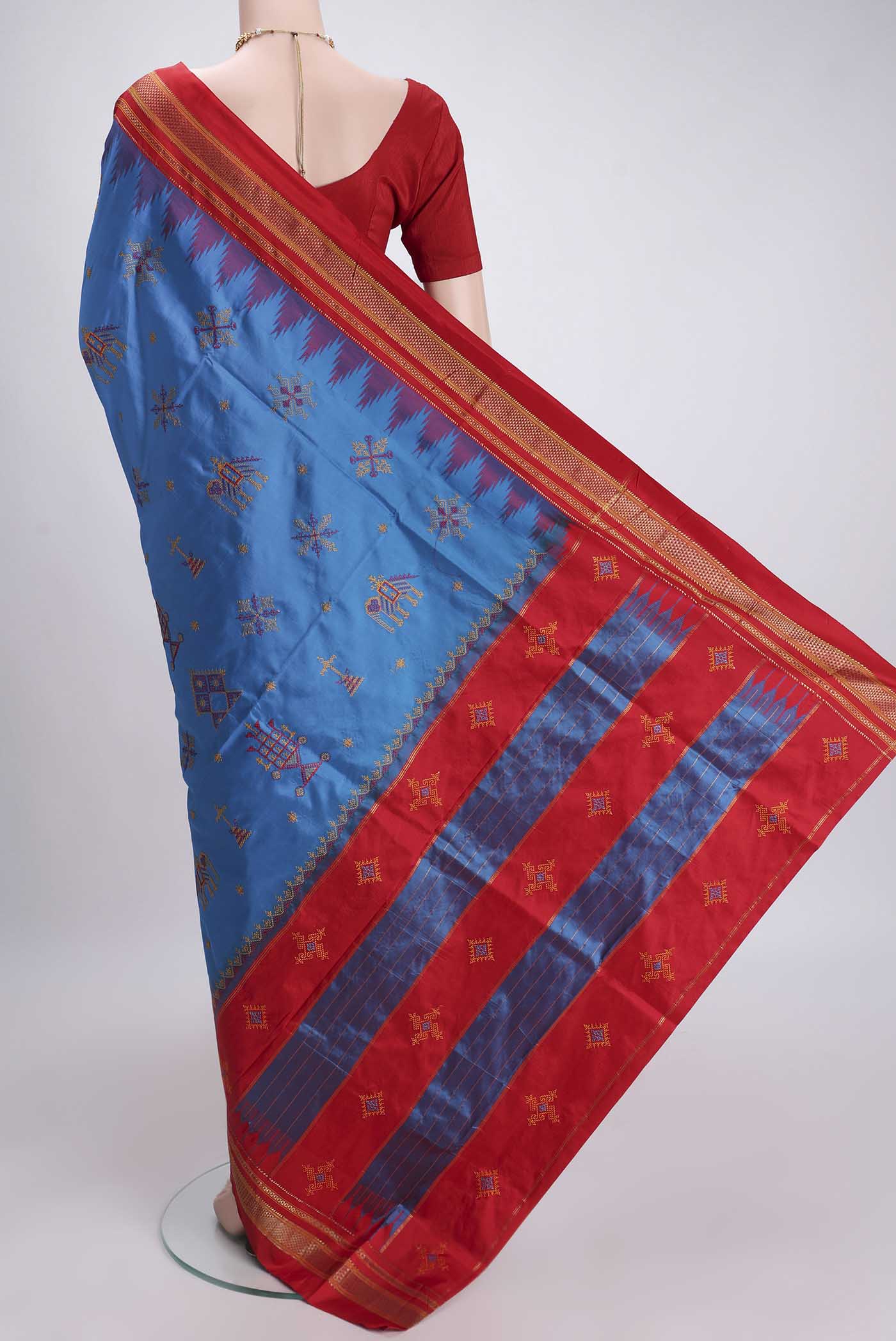 Flat view of Blue Bangalore Silk Saree with Embroidery on the body and Temple Border. 