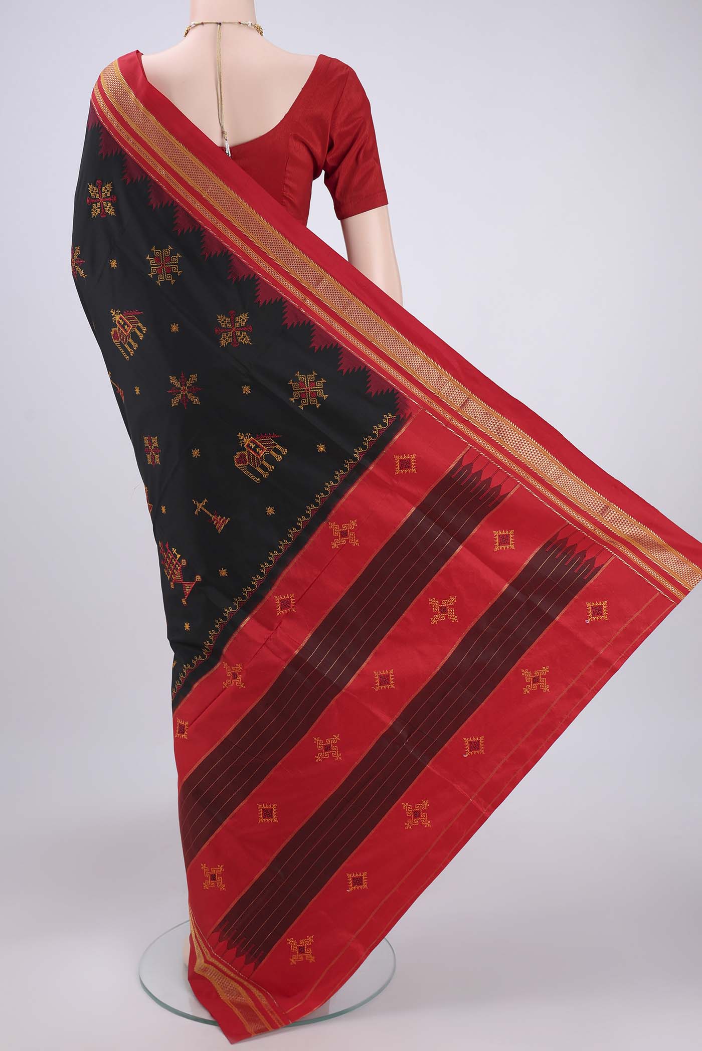 Flat view of Black Bangalore Silk Saree with Embroidery on the body and Temple Border. 